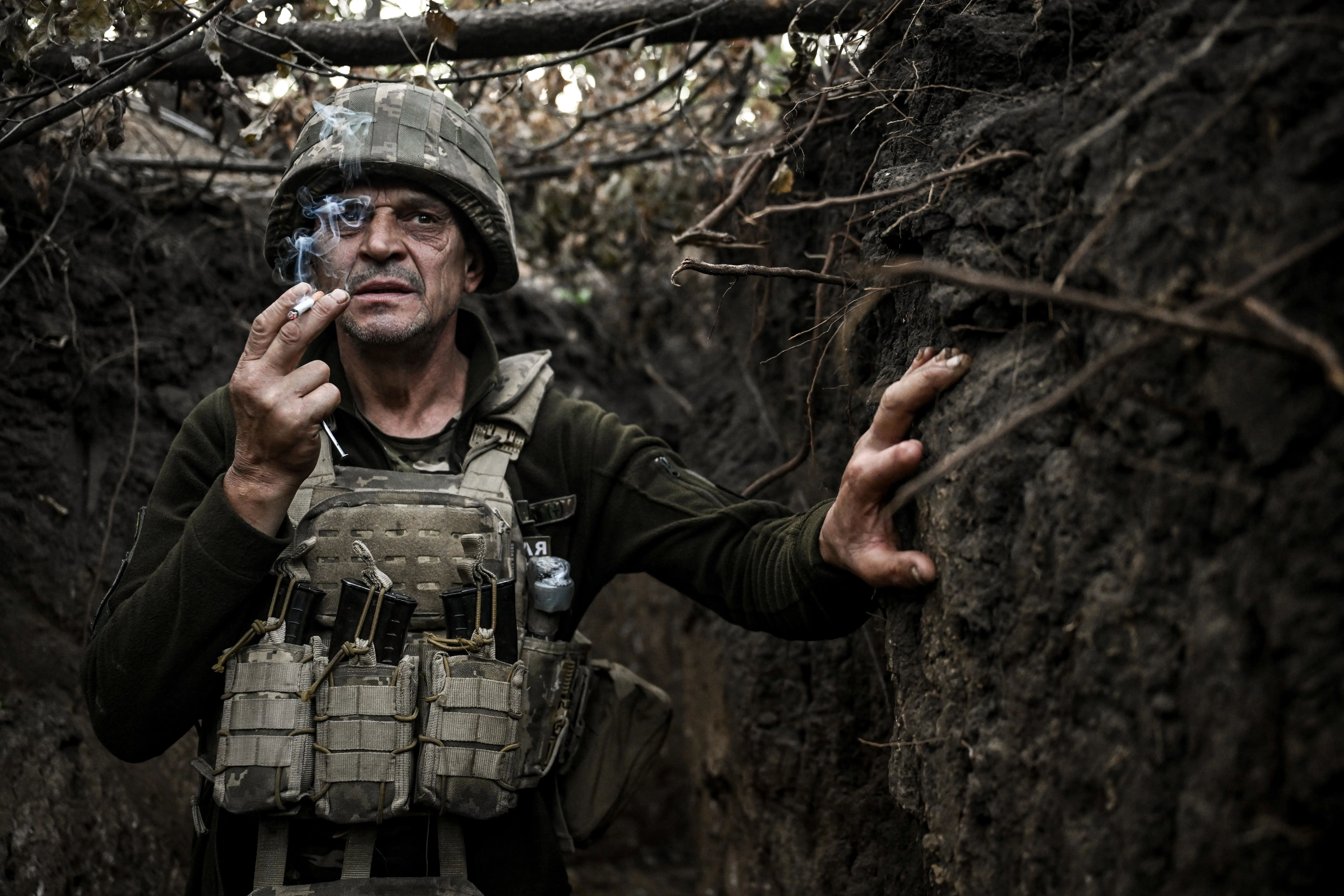 A Ukrainia gunner smokes a cigarette in a trench.
