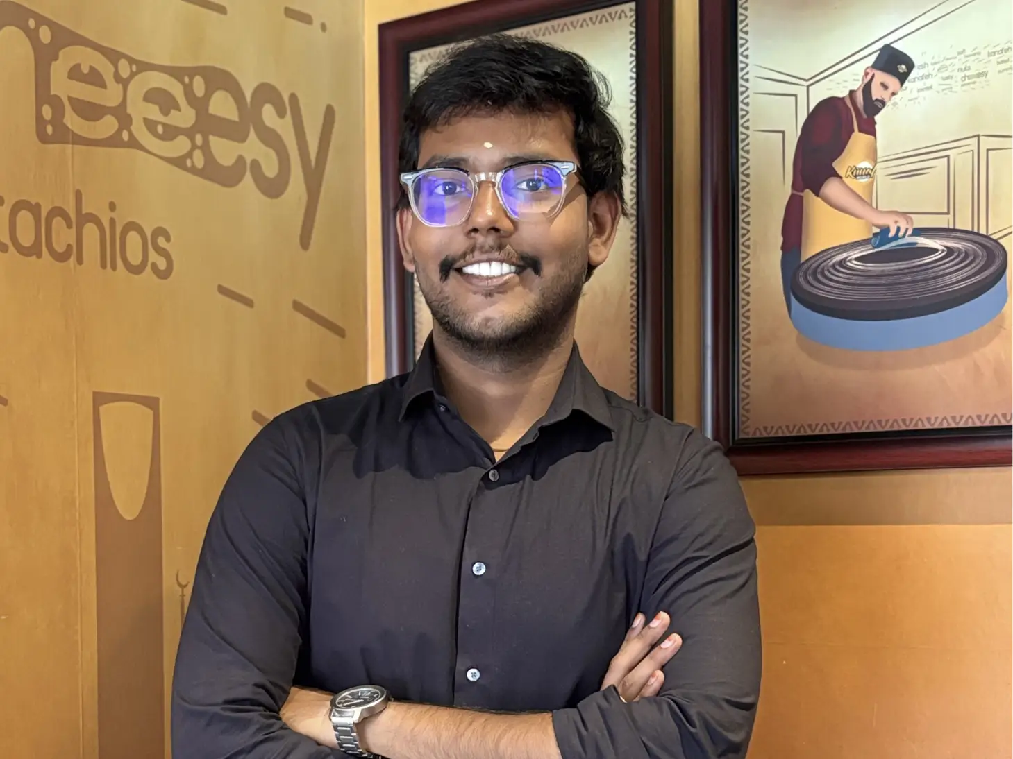 Rathesh Prabakar is wearing a black shirt.