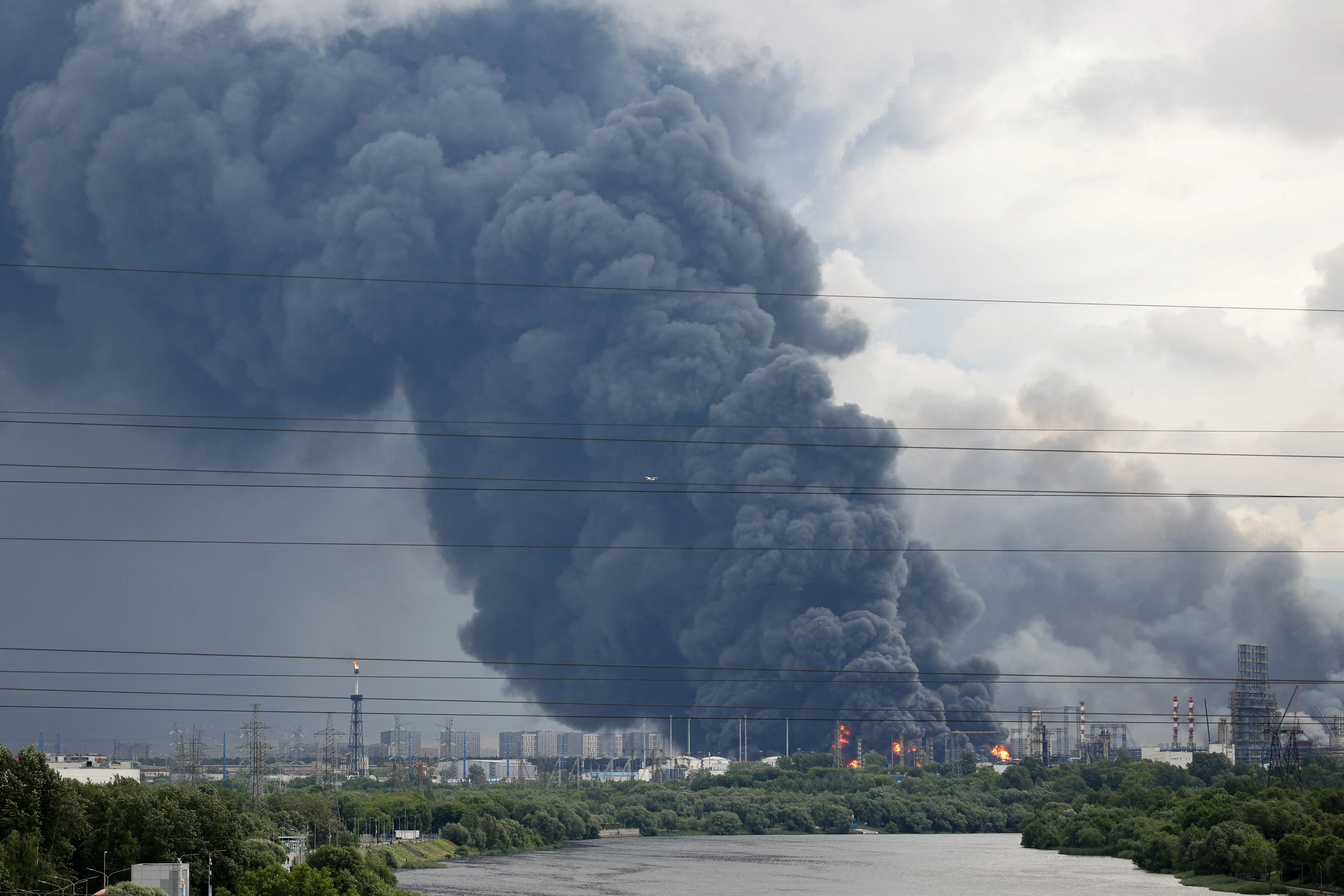 Thick plumes of smoke with flames rise from an oil refinery following a Ukrainian drone attack in Moscow, June 18, 2026, in this picture obtained from social media.