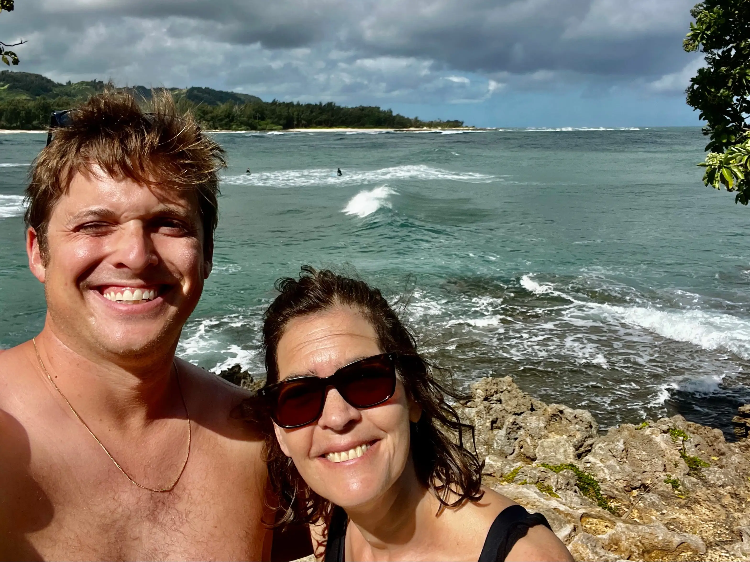 Allison Tibaldi  and her son taling a selfie in front of the ocean in hawaii