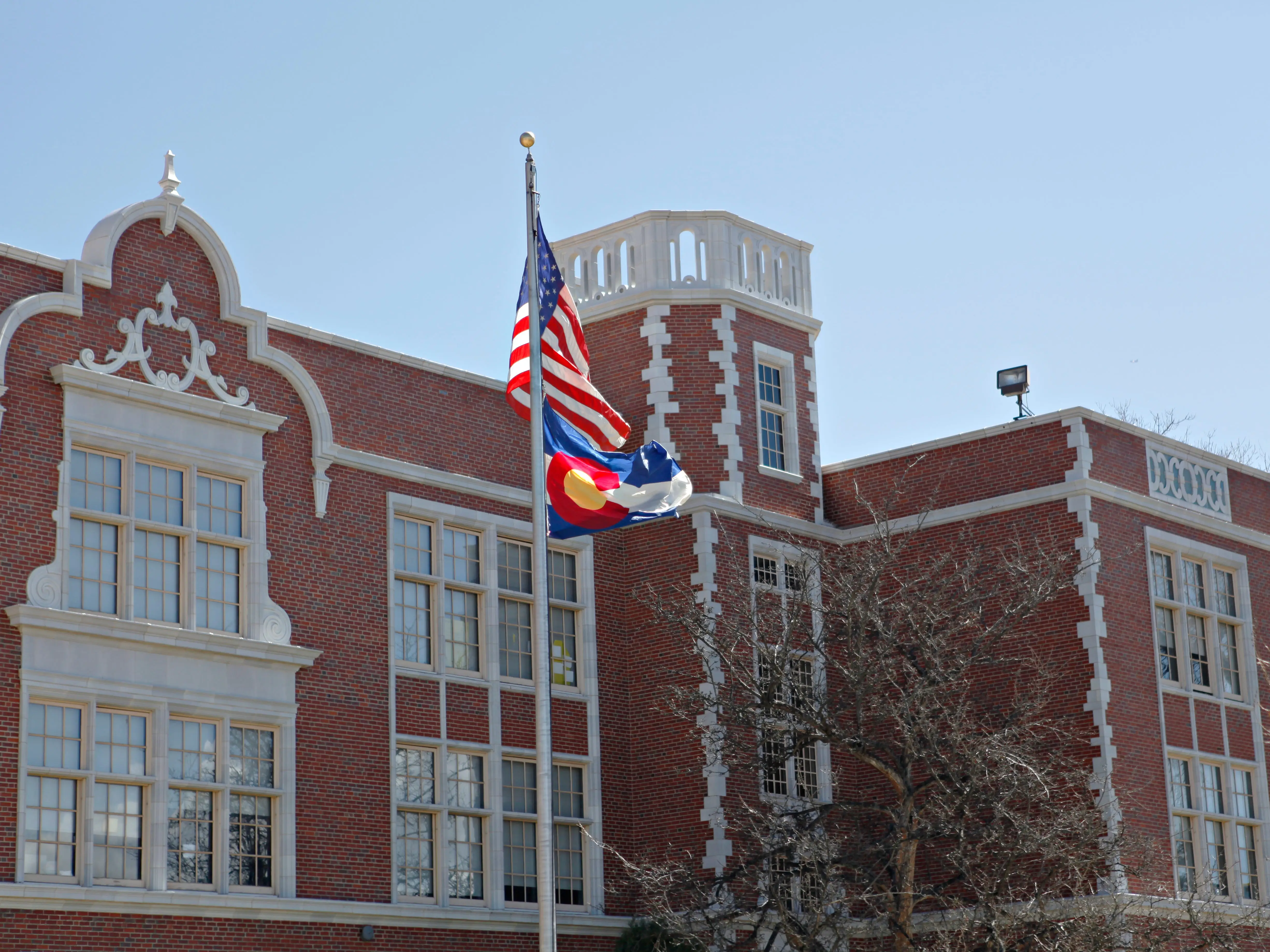 US and Colorado flags outside of East High School in Denver, Colorado.