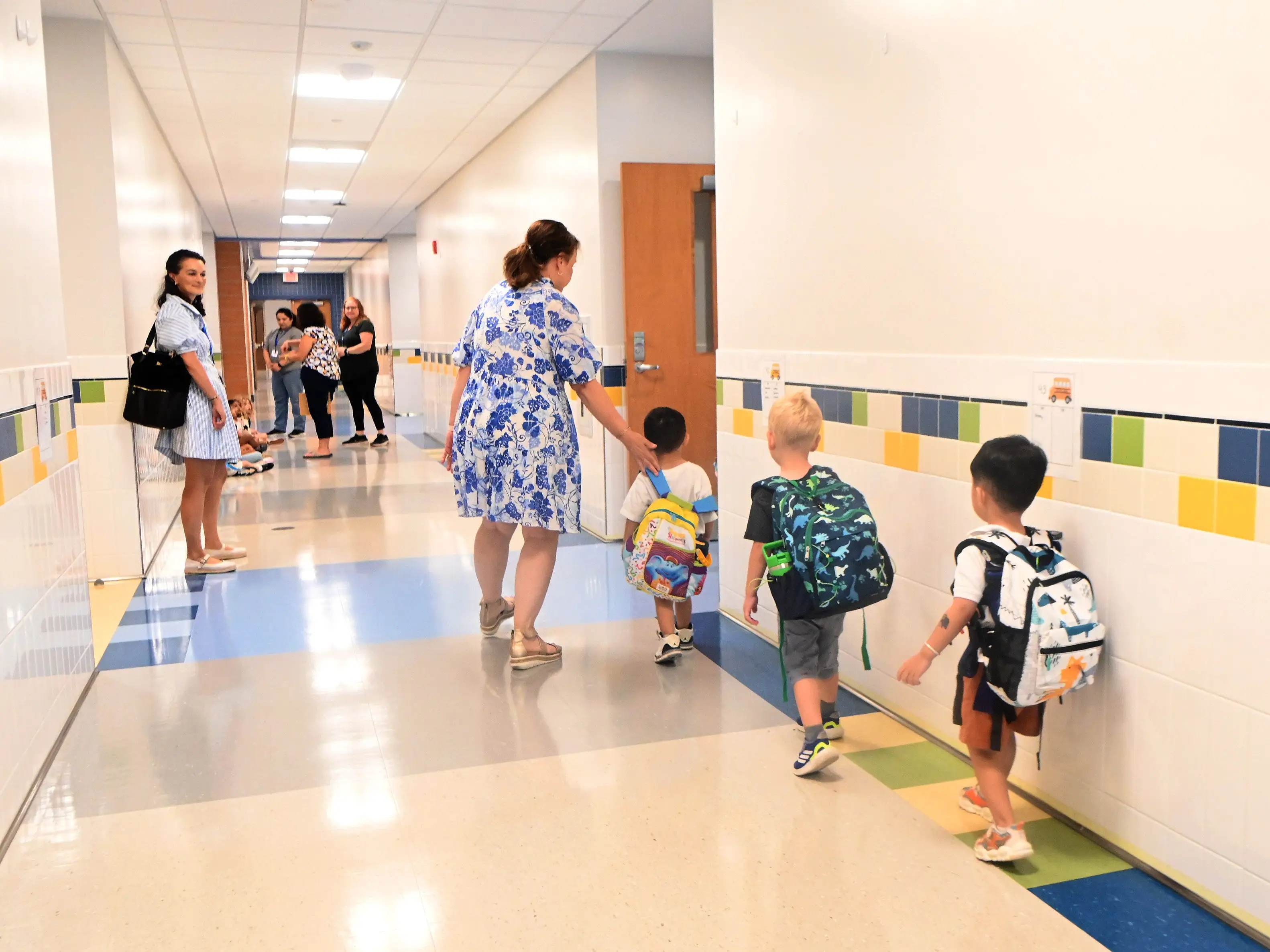 Teacher walking with students in Pleasant Valley Elementary School in South Windsor, Connecticut.