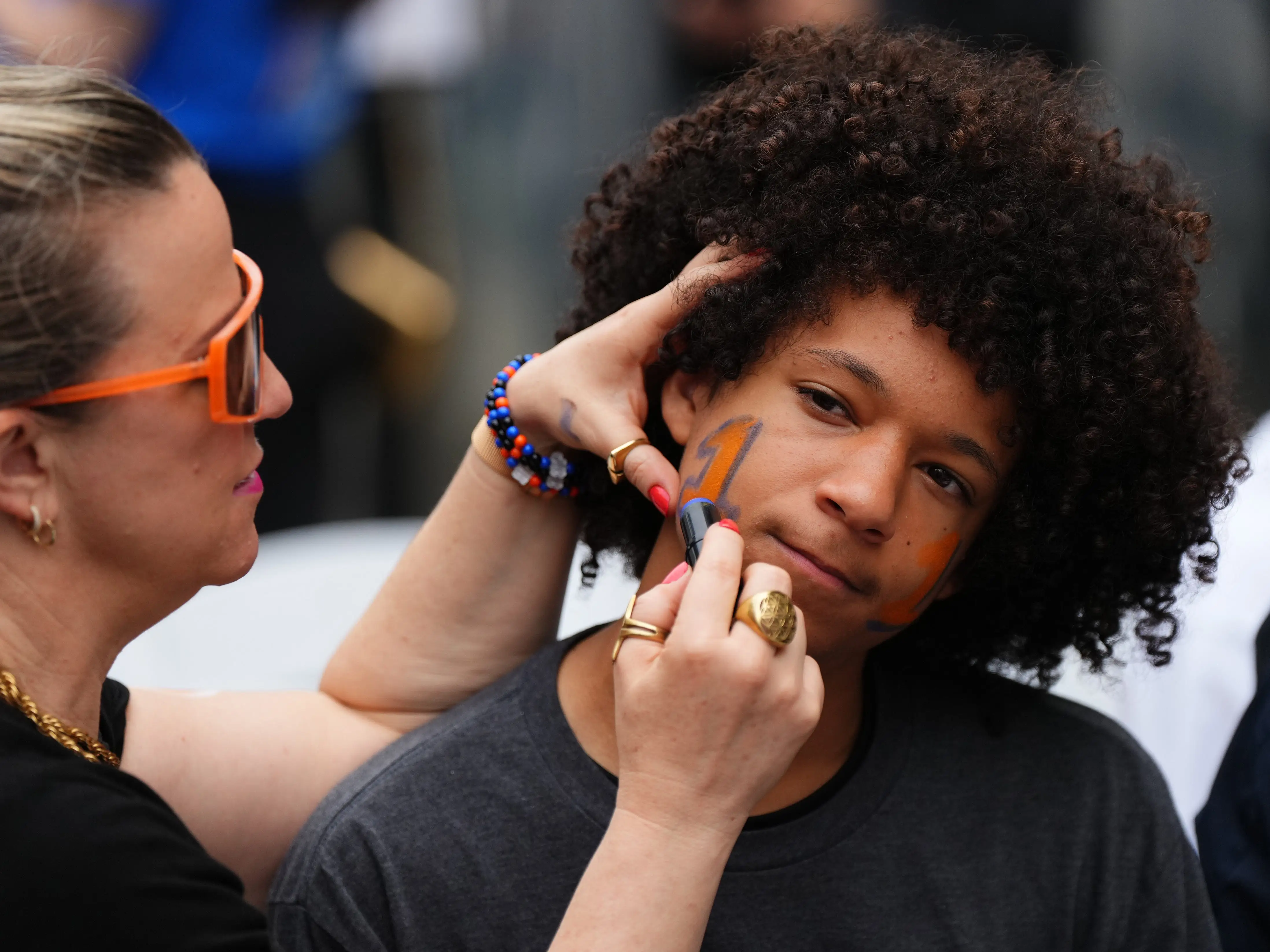Khalil Seifullah has his face painted by his mother Annie before the New York Knicks Championship ticker tape parade.