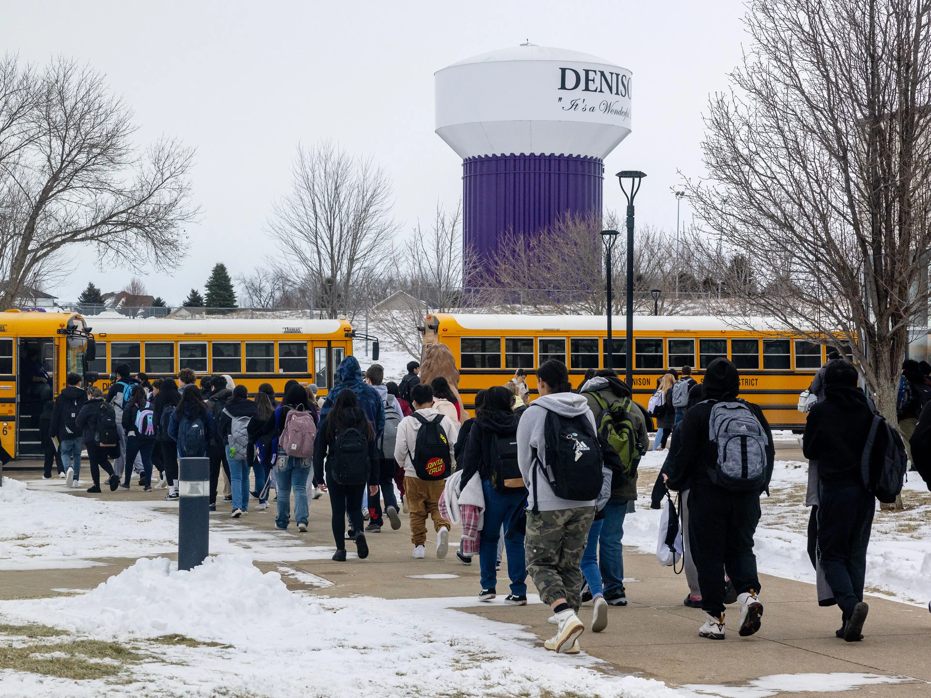 Students boarding buses at Denison High School in Denison, Iowa.