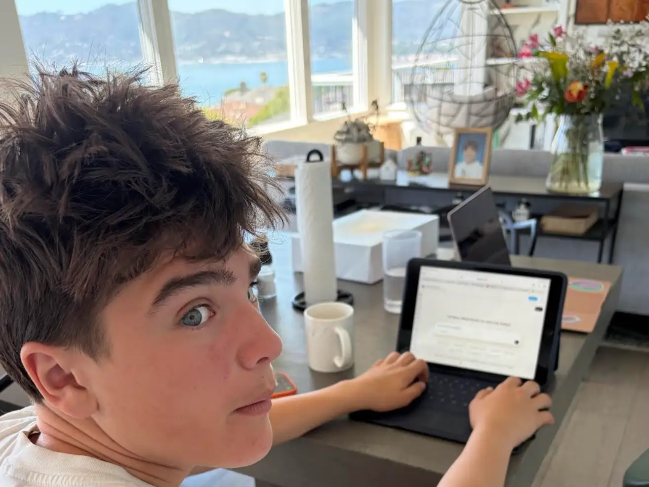 Amanda Hyslop son on his tablet using ChatGPT