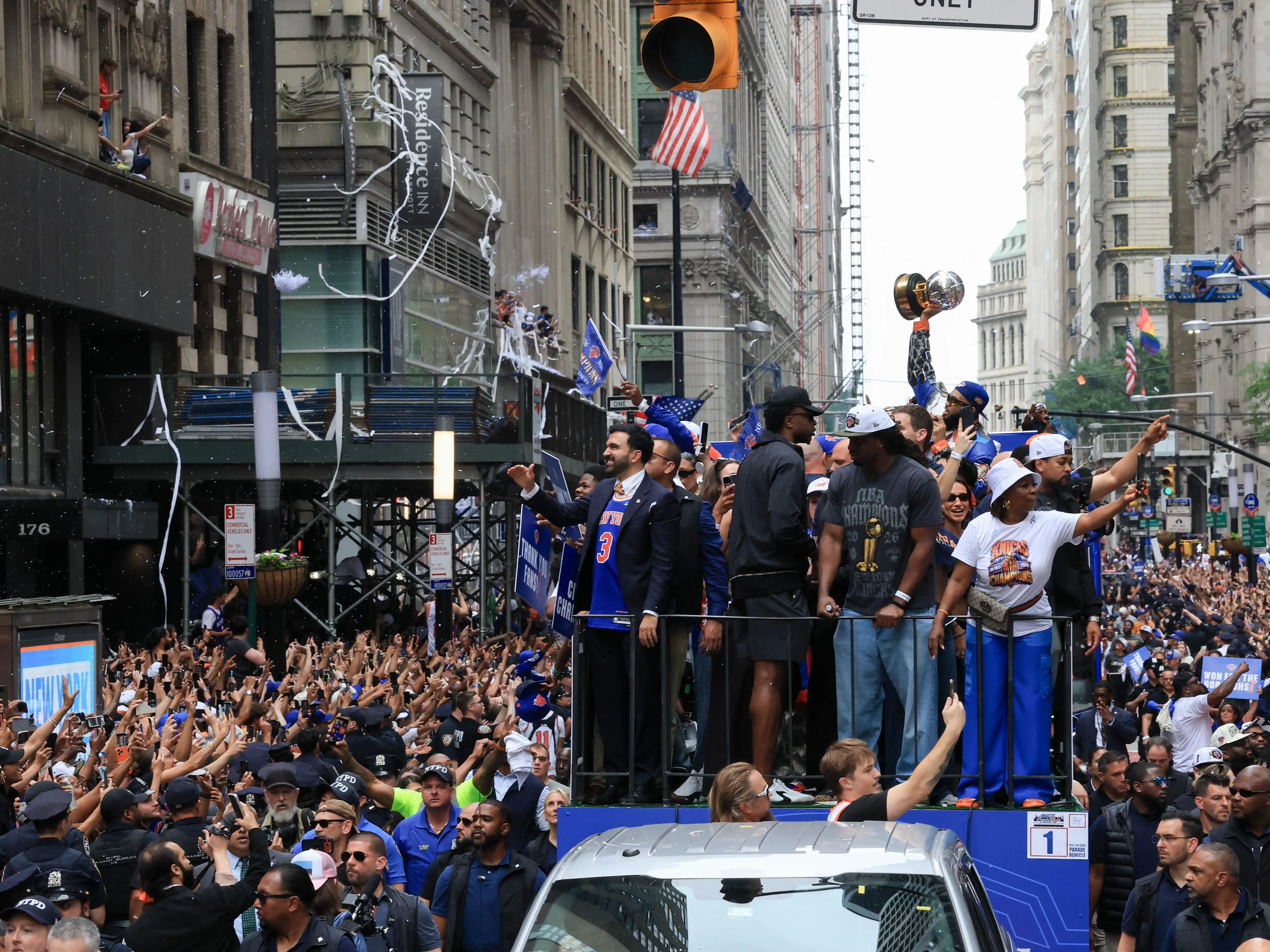 Members of the New York Knicks joined by New York City Mayor Zohran Mamdani ride atop an open-top bus during a championship ticker-tape parade celebrating the team's NBA Finals victory in New York City on June 18, 2026. (
