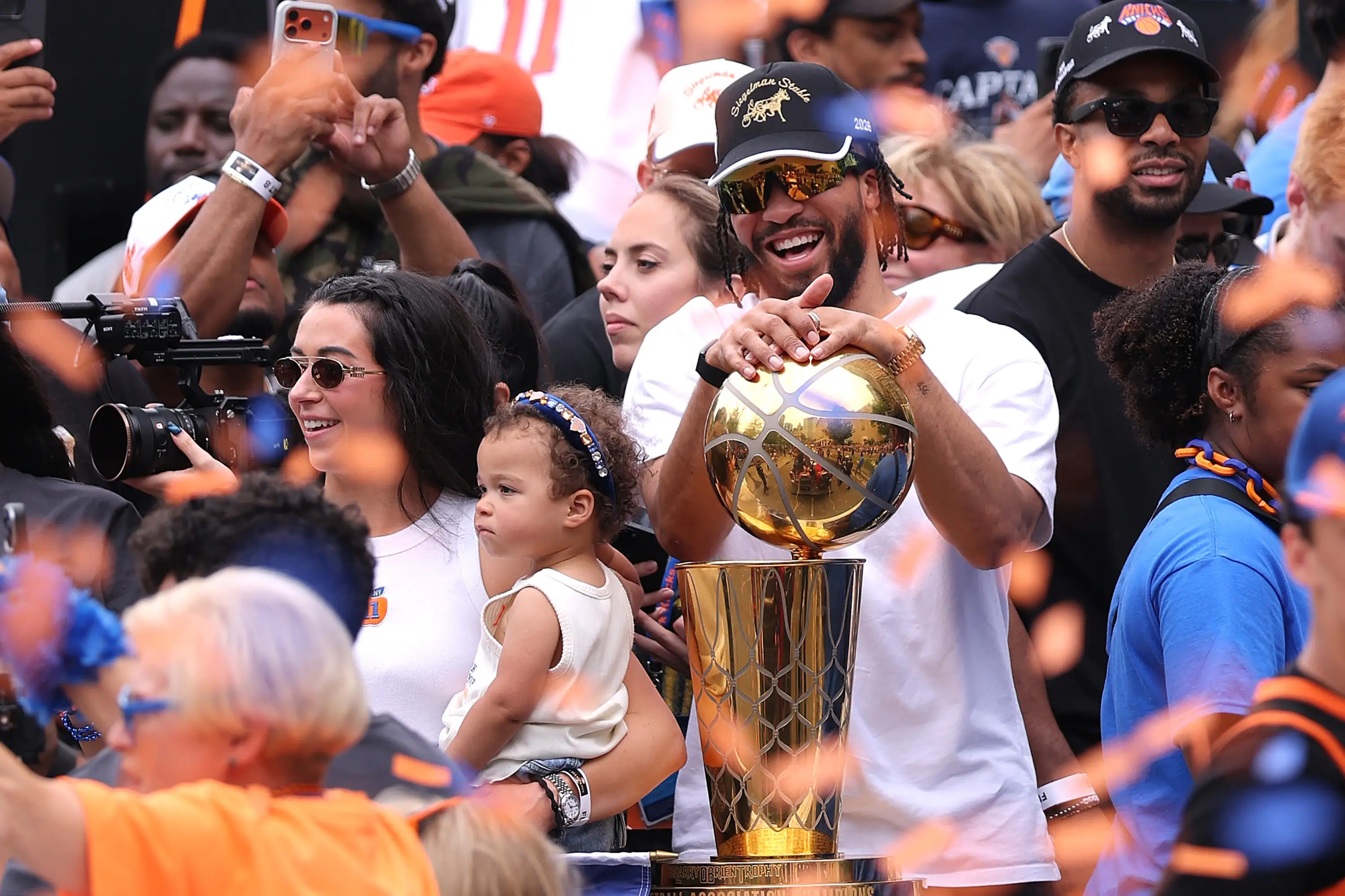 Jalen Brunson celebrates with the Larry O'Brien Championship Trophy during the Knicks parade.