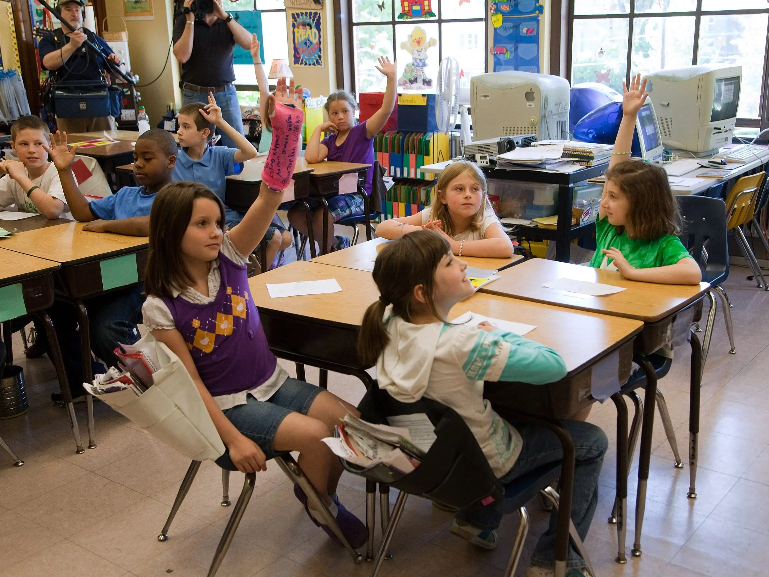 Students raise their hands at Mount Washington Elementary School in Cincinnati, Ohio.