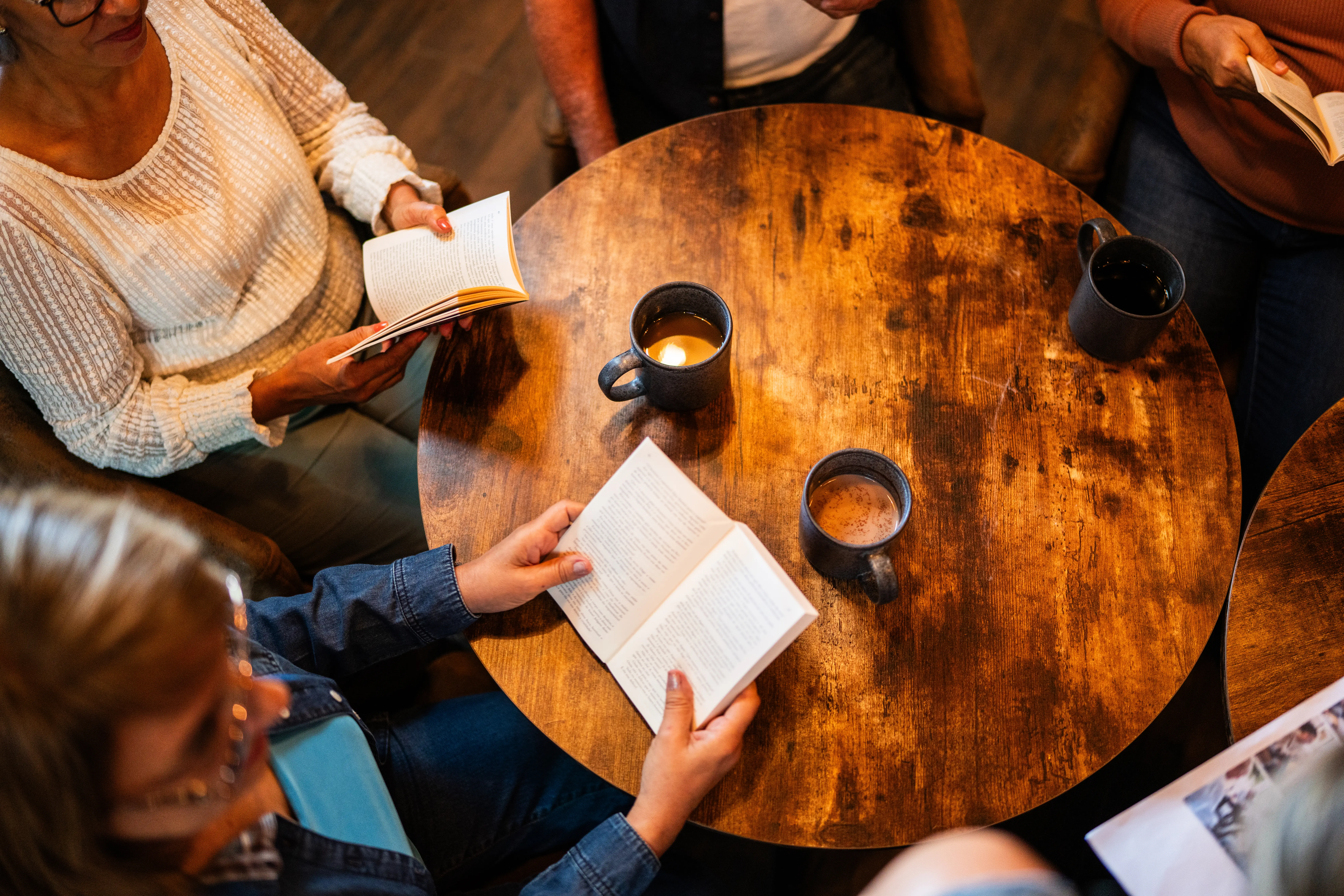 Aerial view of people in coffee shop reading books