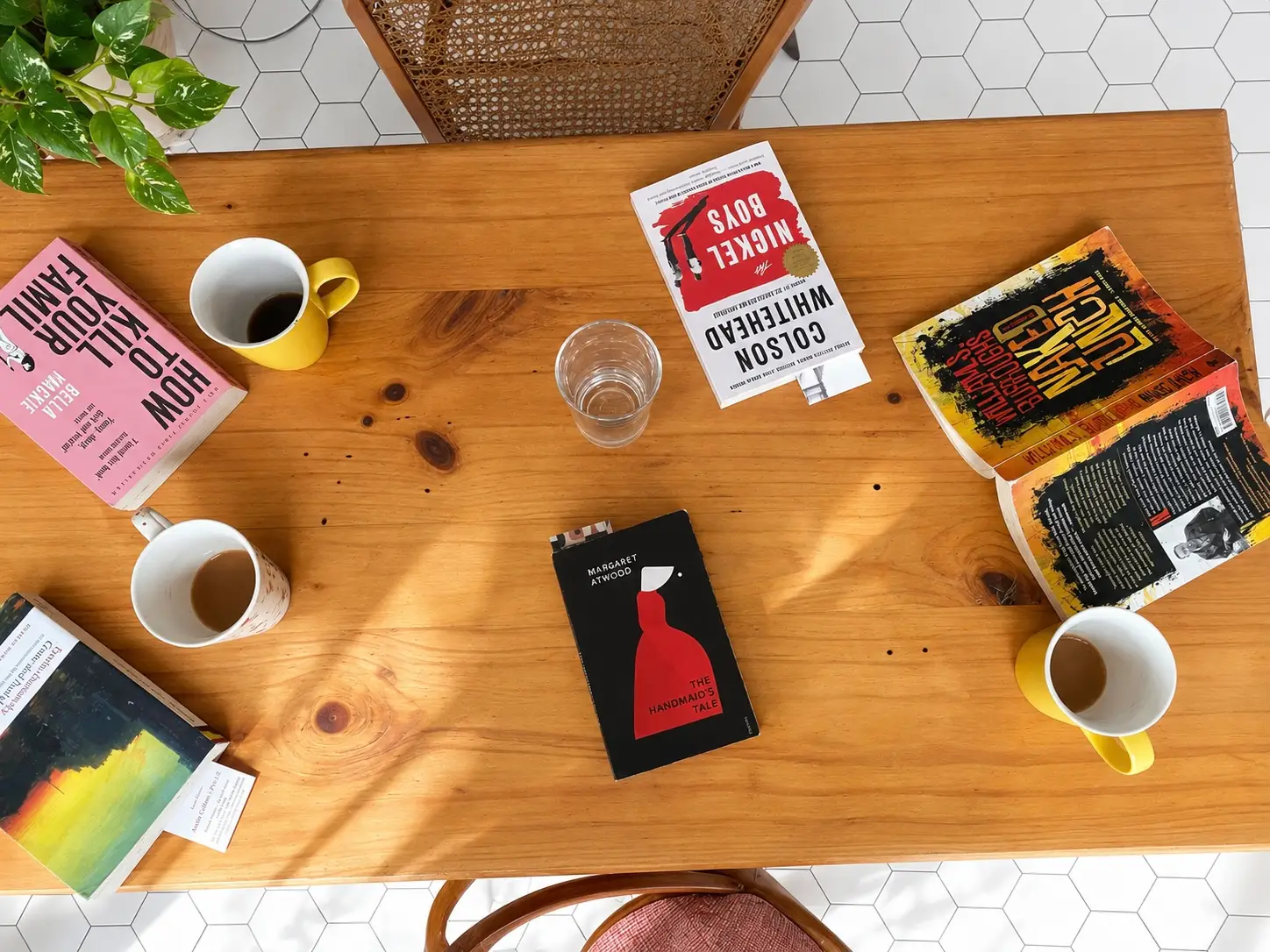 View of table with coffee cups, books in cafe