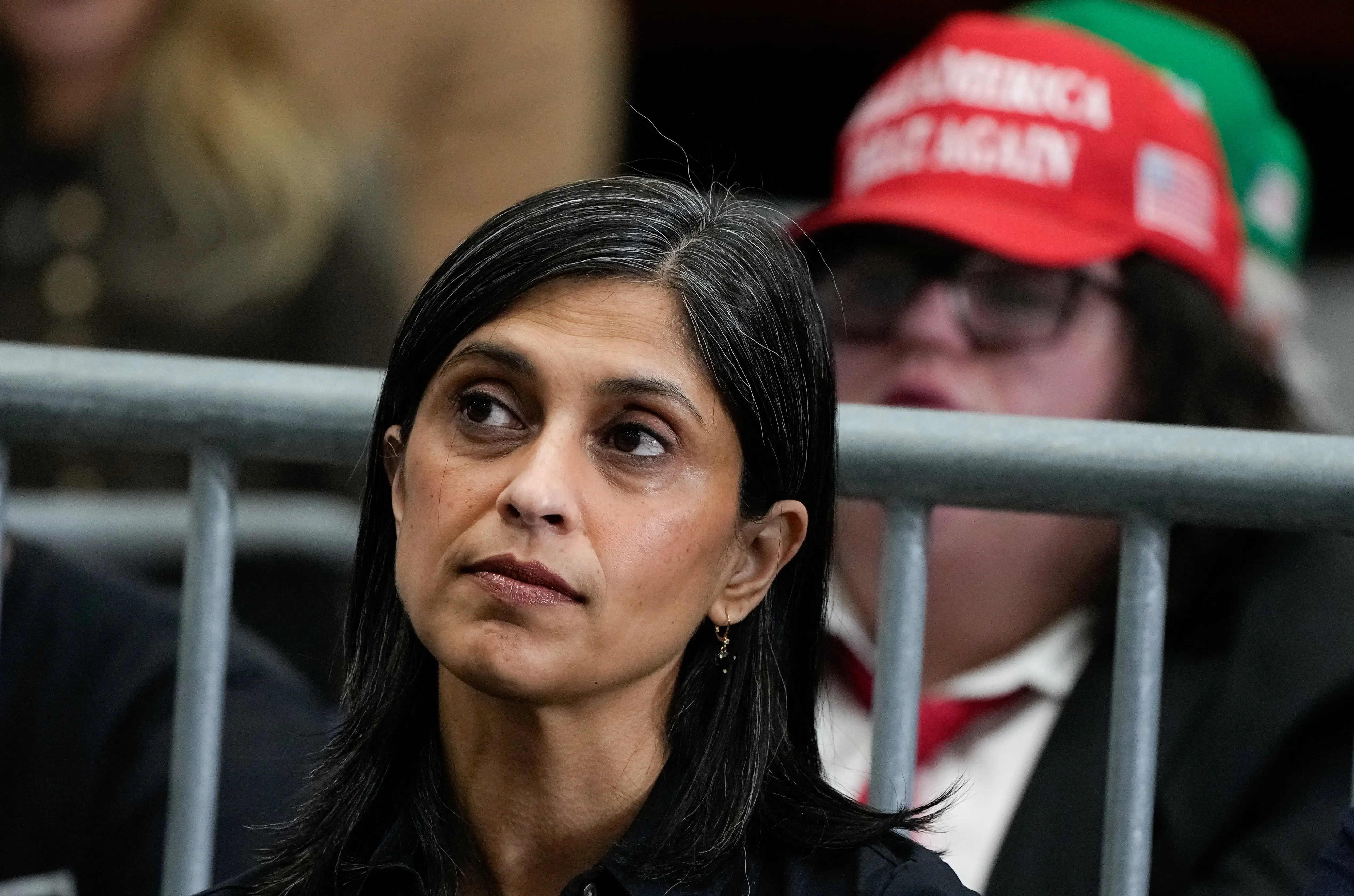 Usha Vance with a MAGA hat in the background.