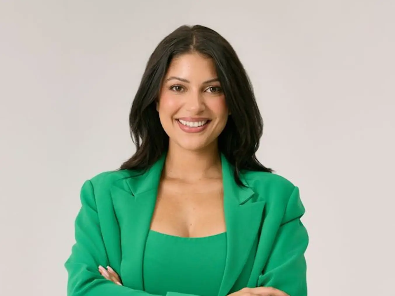 headshot of a woman in an all green outfit