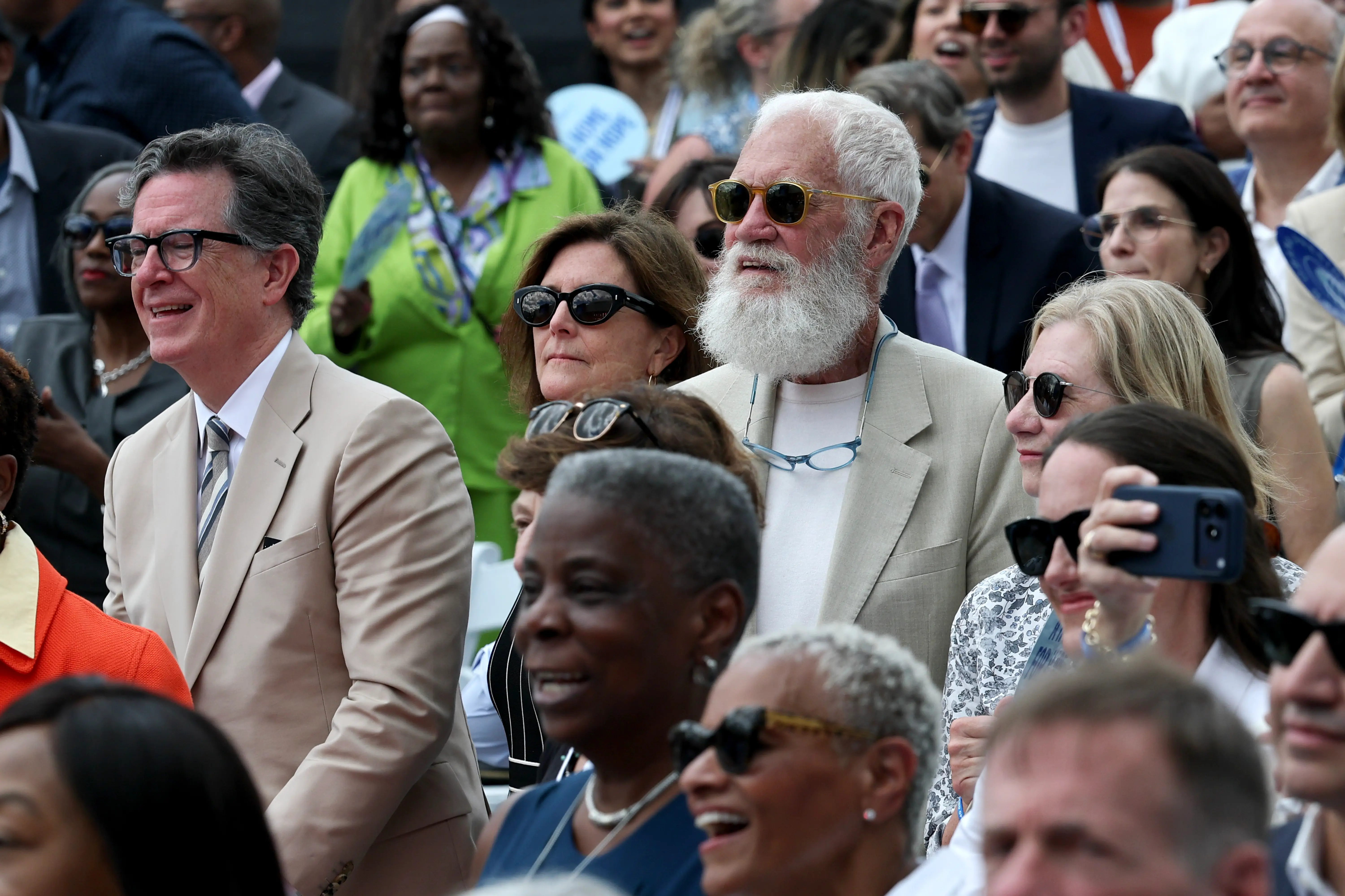 Stephen Colbert (L) and David Letterman look on during the dedication ceremony for the opening of the Barack Obama Presidential Center.