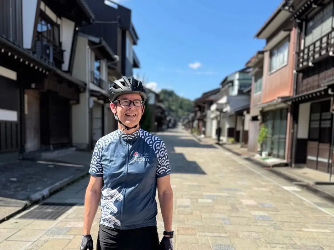 A man on a street in rural Japan.