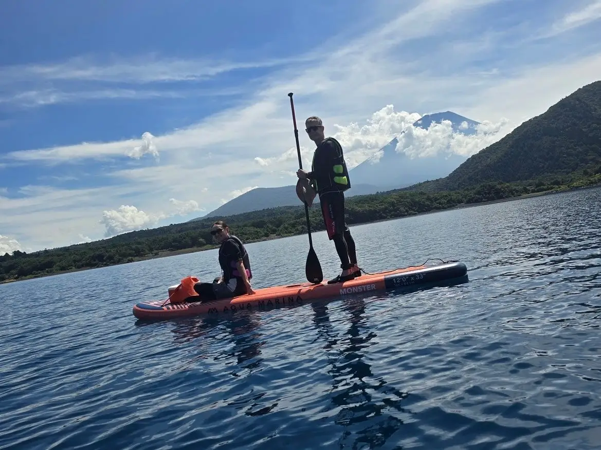 Two people paddleboarding near Mount Fuji, Japan.