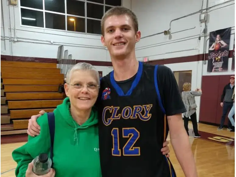 Mother and son on a basketball court.