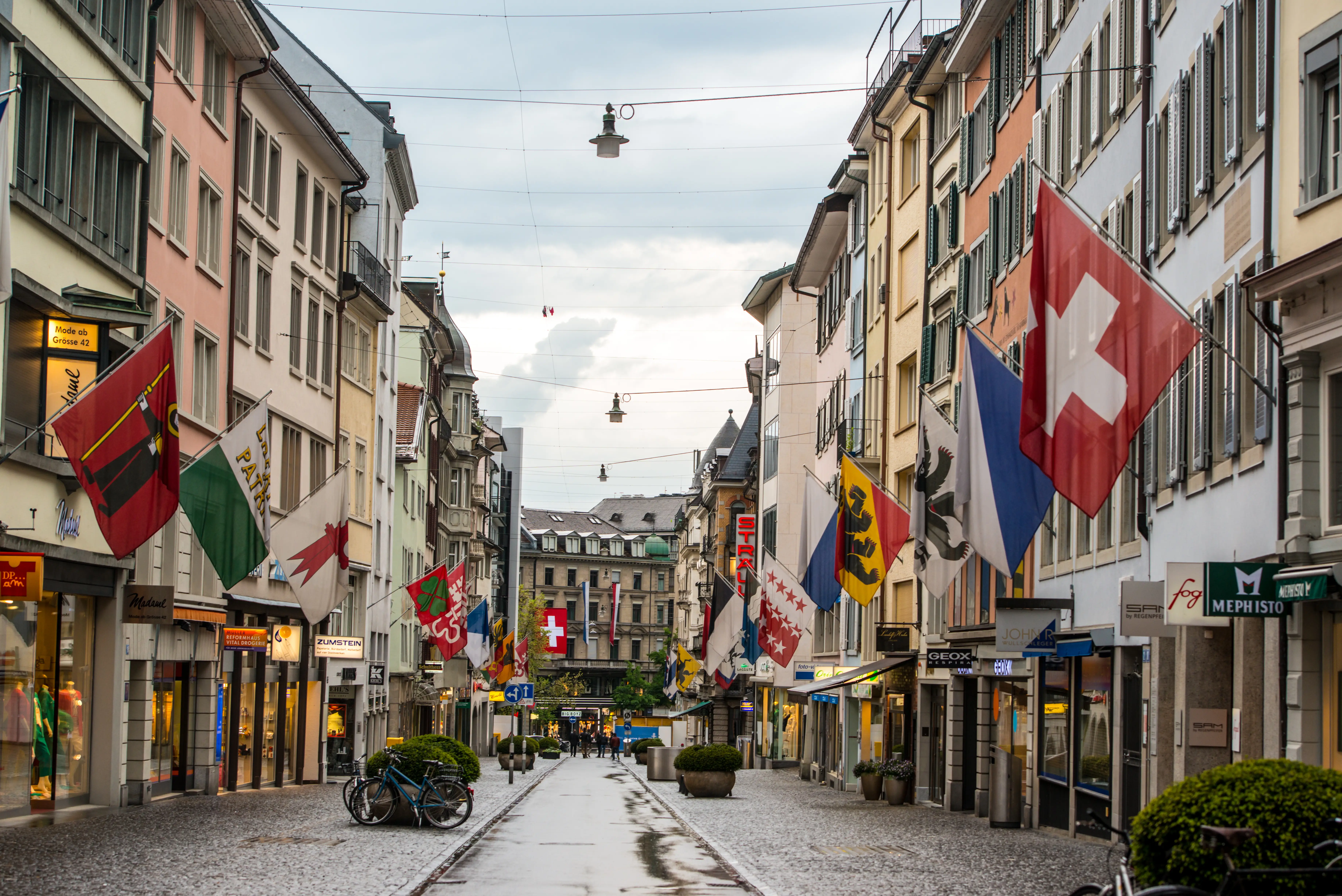 Rainy Zurich street with shops
