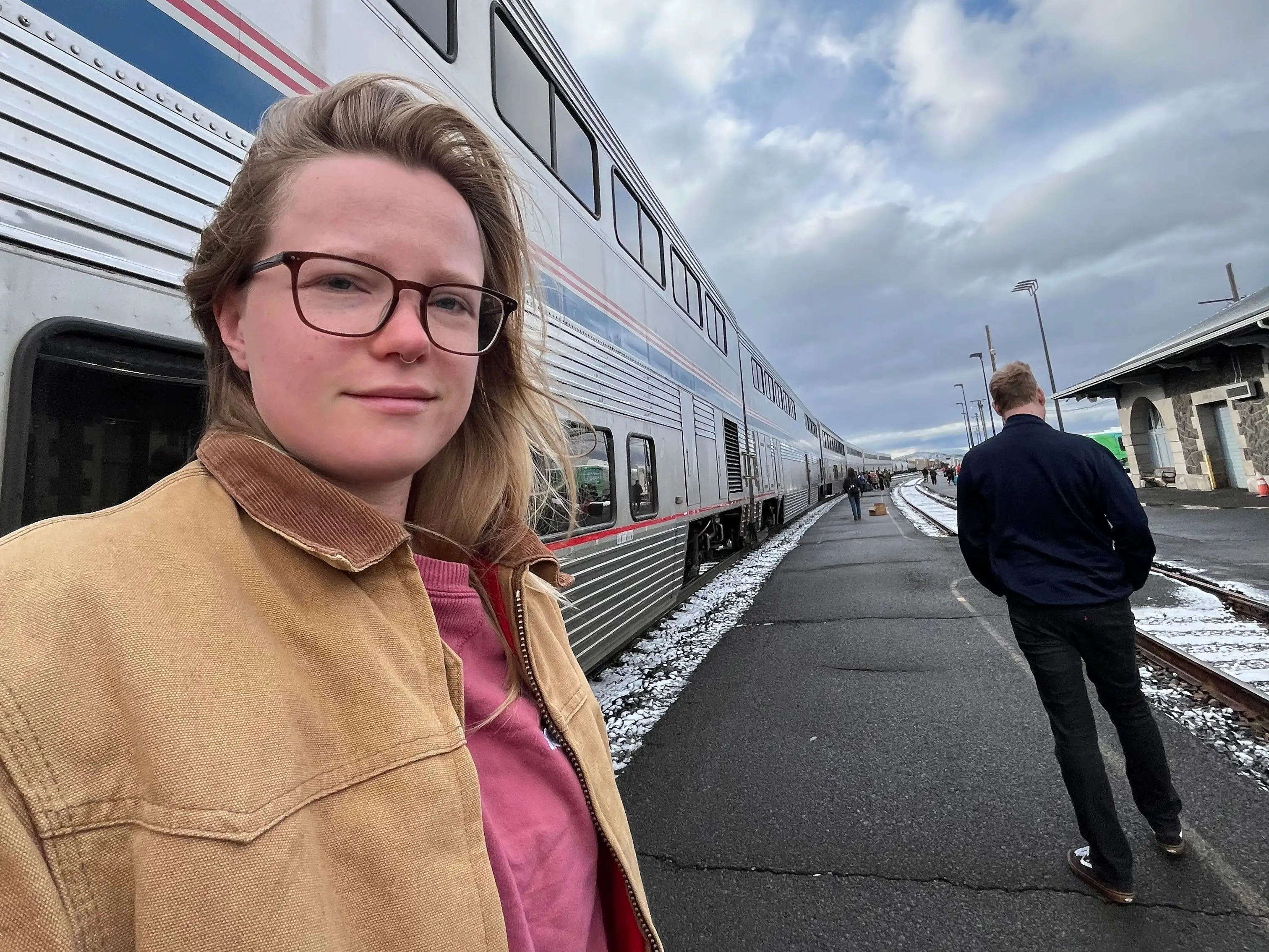 A woman stepping off an Amtrak train.