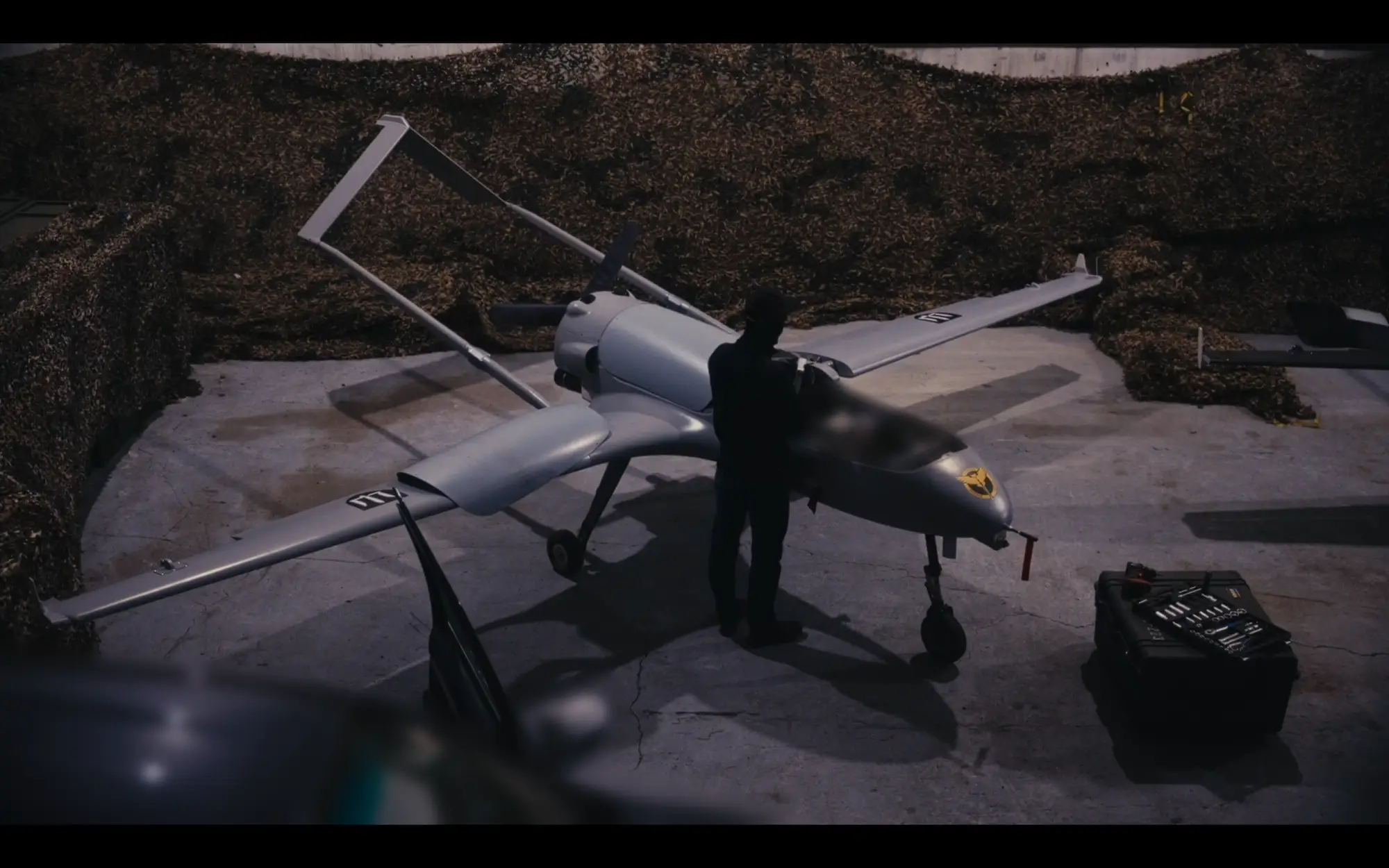 A technician with Ukraine's military intelligence agency, the GUR, prepares a Liutyi attack drone for a strike well inside Russia.