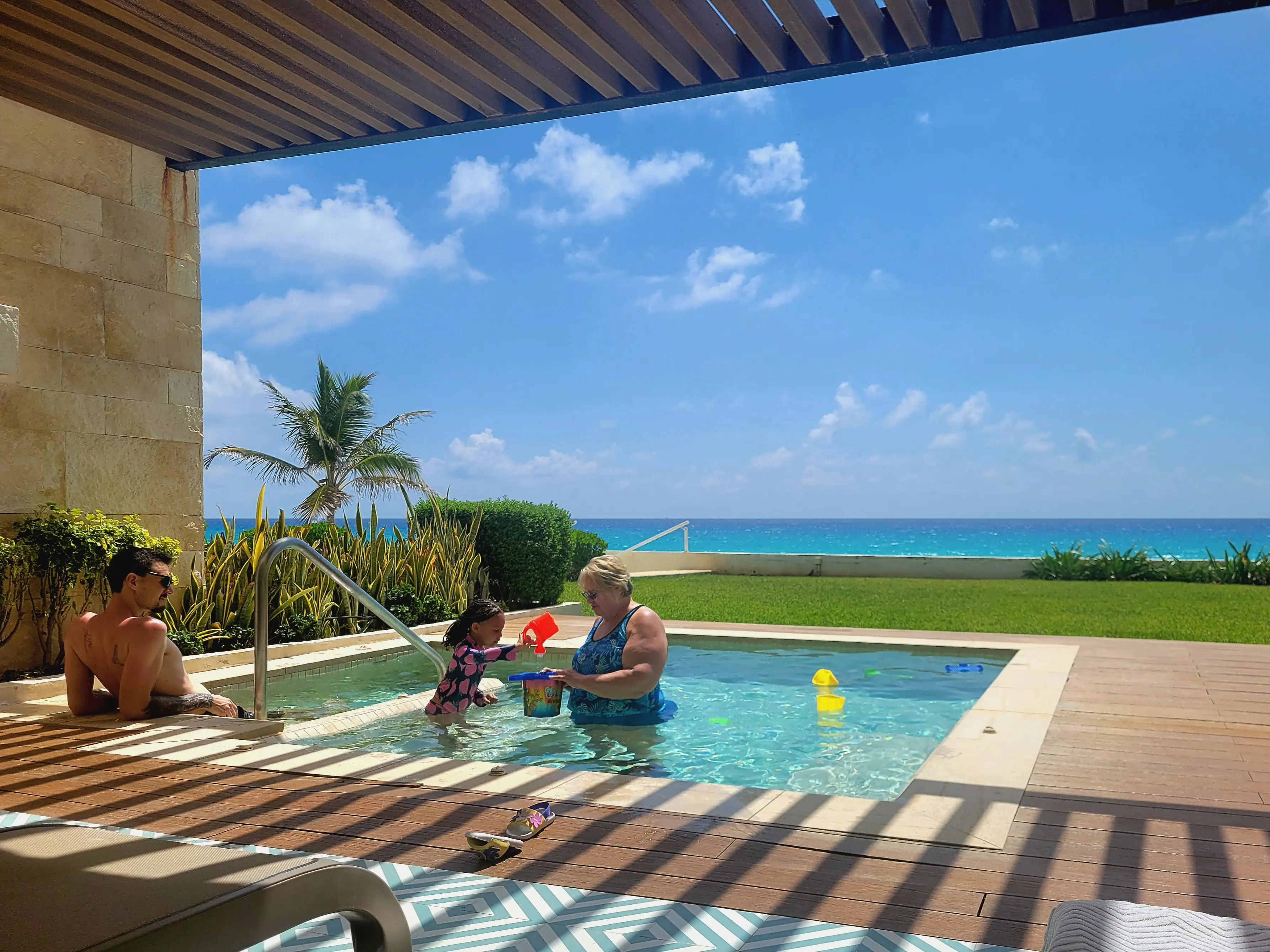 Cher's husband, daughter, and mother-in-law play in a plunge pool.
