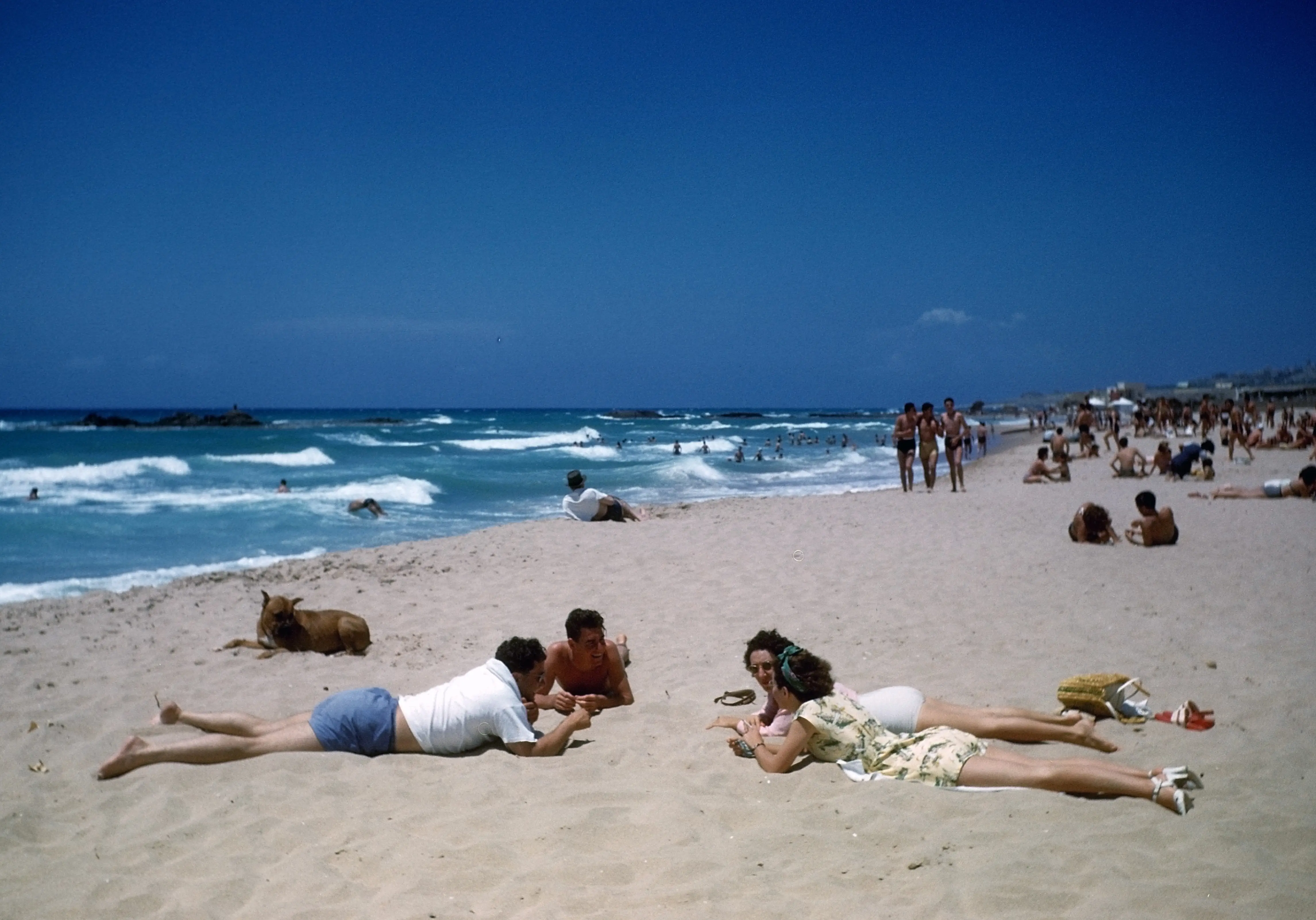 MAY 1948: A view of young couples resting on a beach in Beirut, Lebanon.