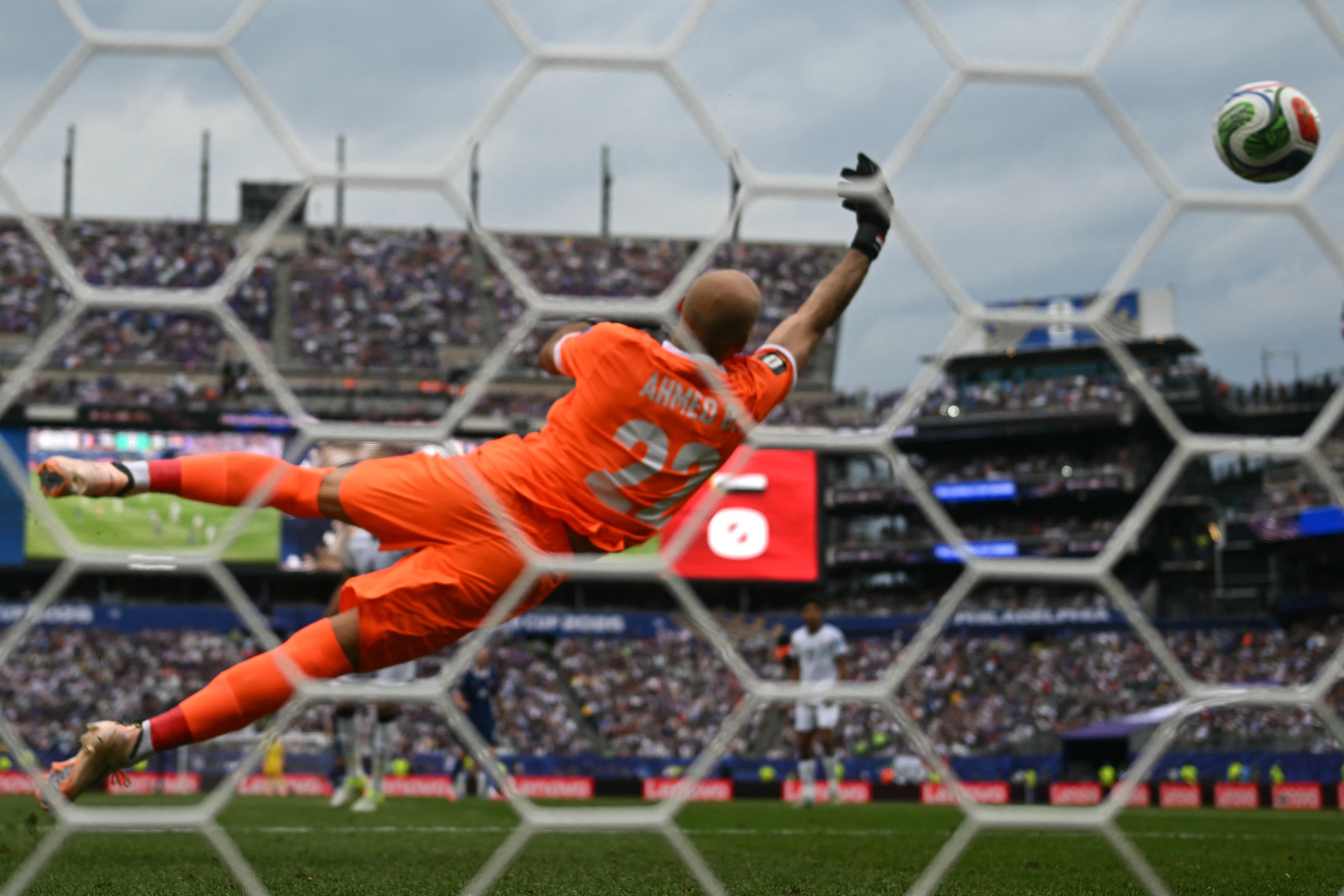 Iraq's goalie saving a goal in World Cup.