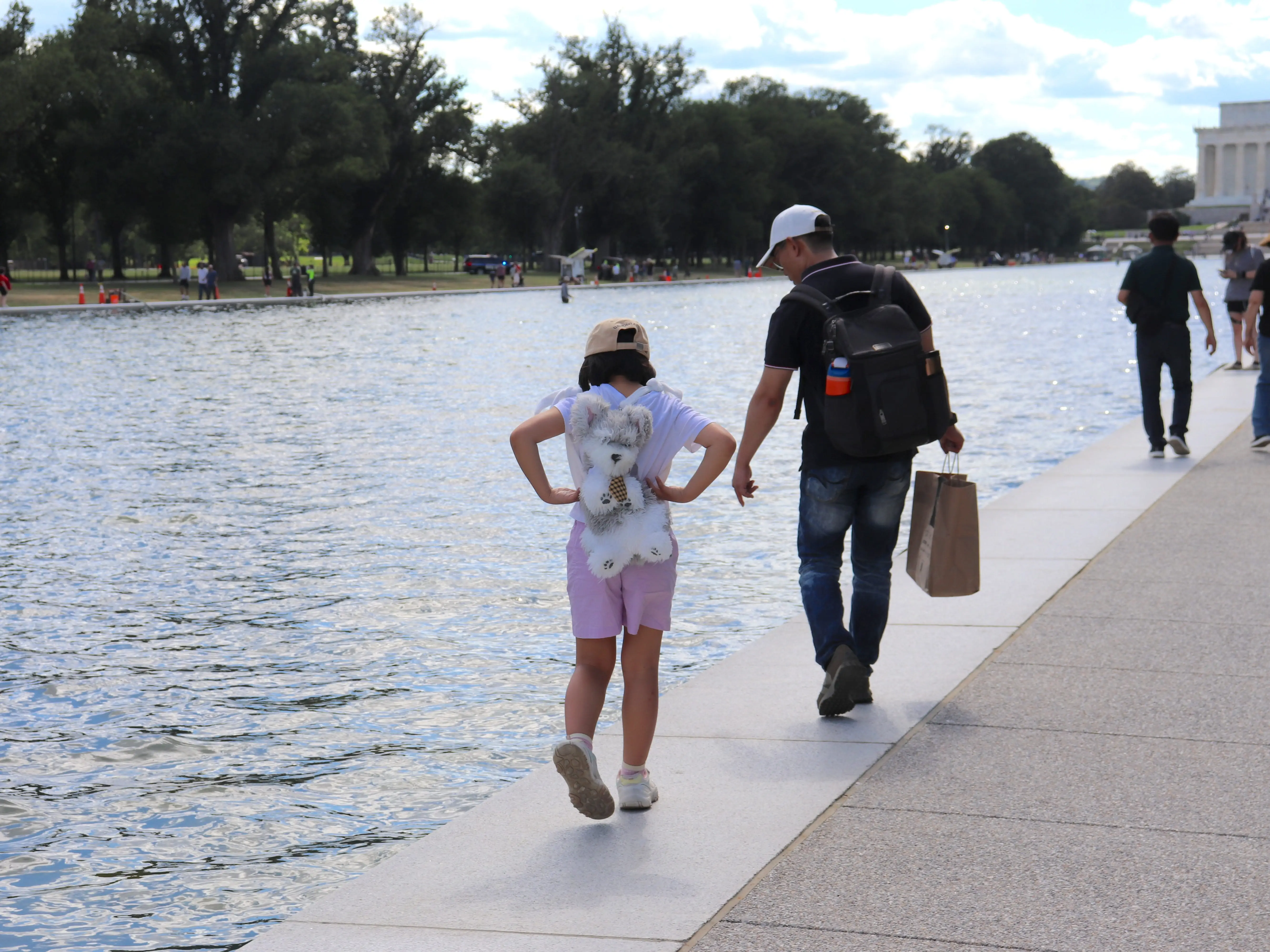 People looking at the Reflecting Pool in Washington DC
