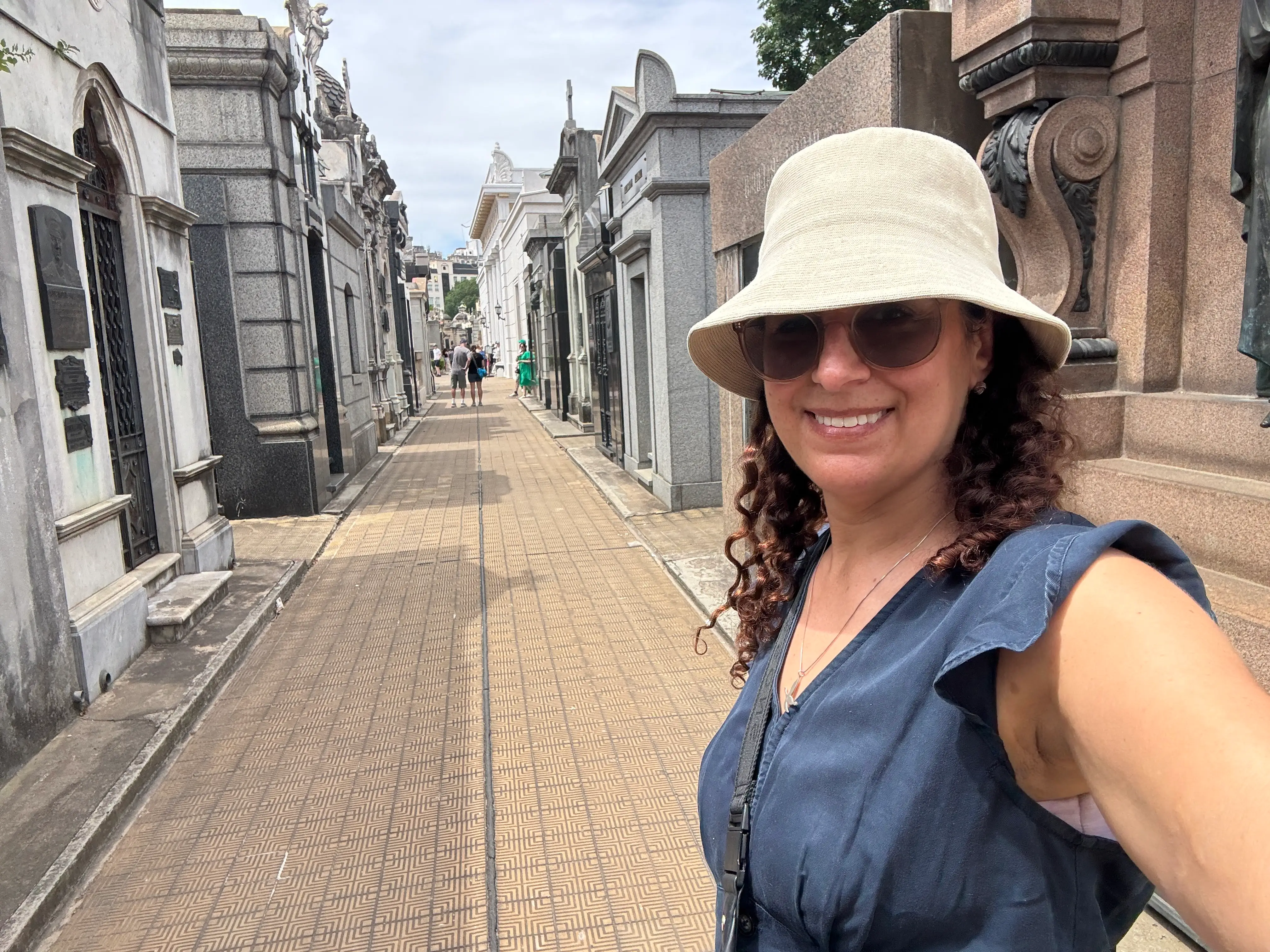 Woman in hat taking selfie on street in Buenos Aires