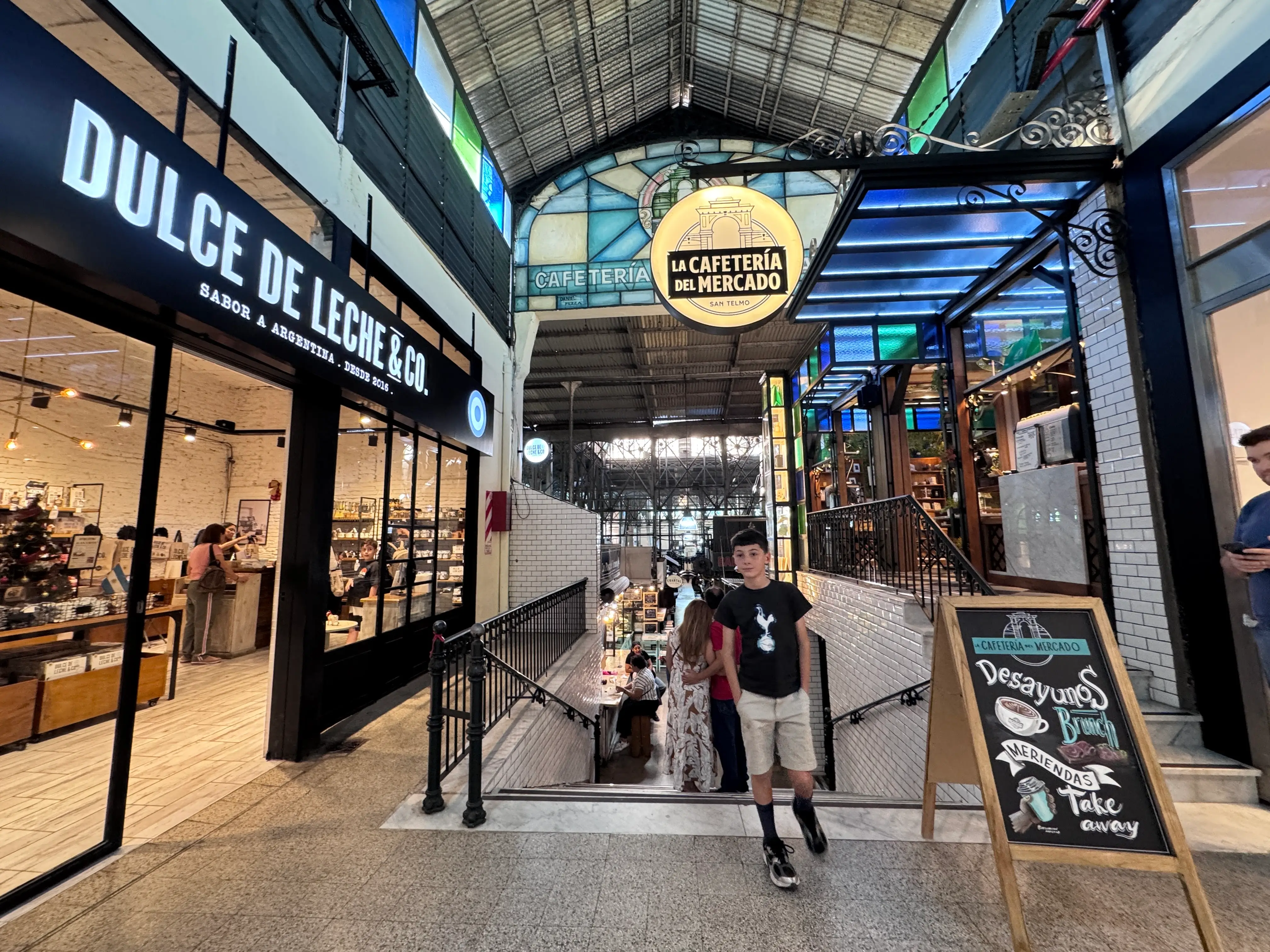 kid walking through indoor area of restaurants, shops in Buenos Aires