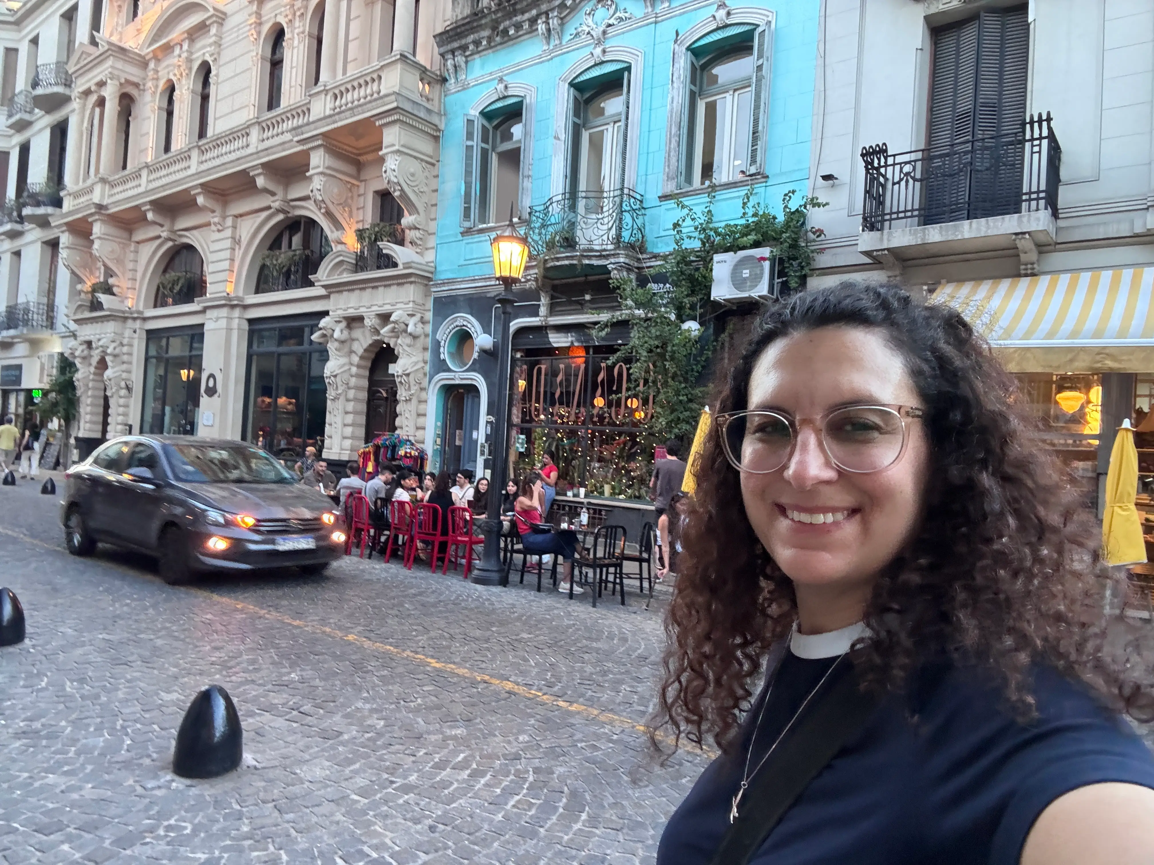 Woman smiling on cobblestone streetin Buenos Aires
