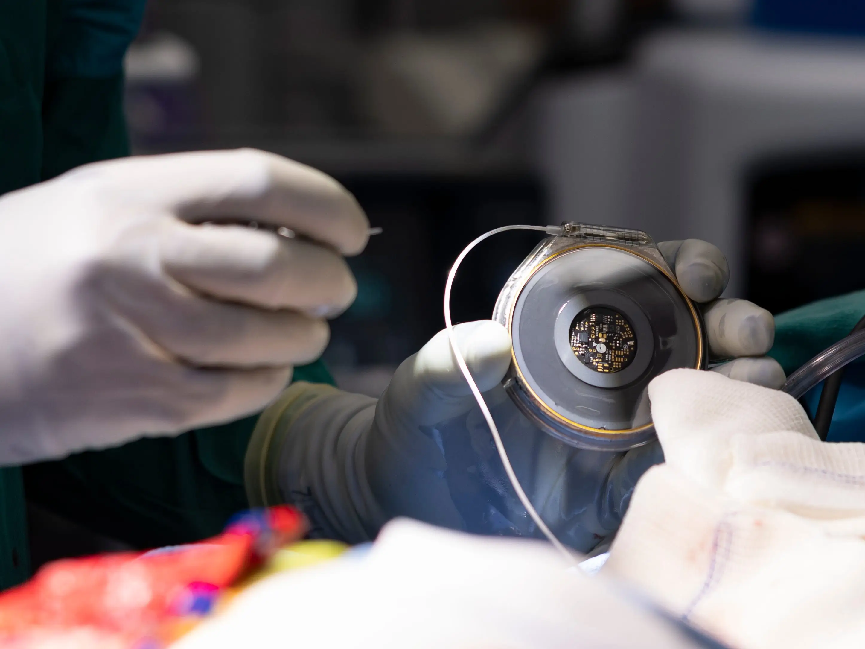 A doctor holds a device in their hands.