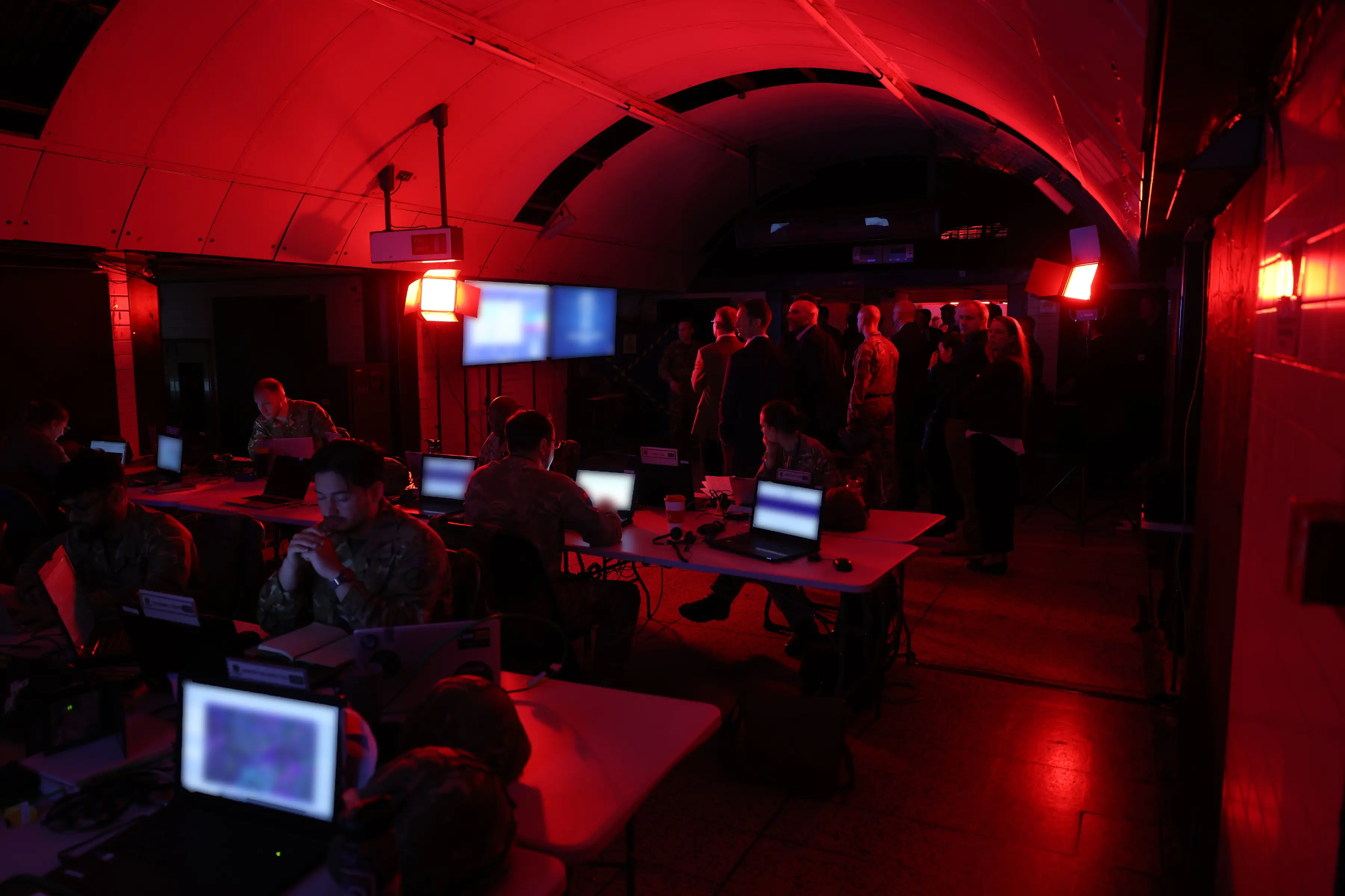 Government officials and media observe an exercise conducted in a tube station.