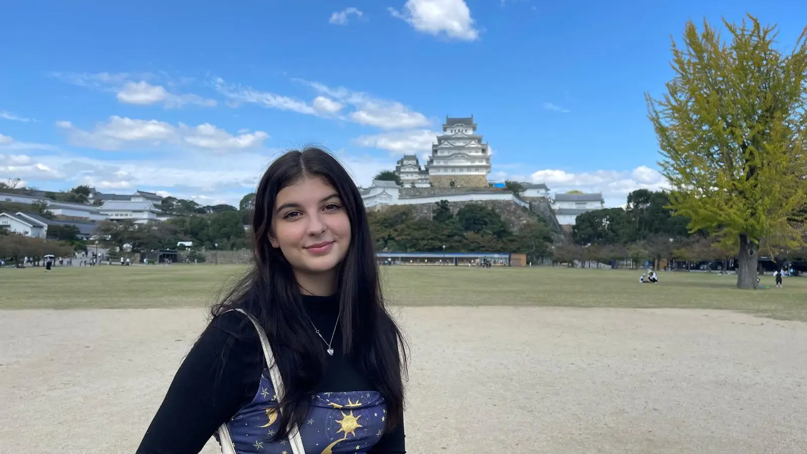 The author is pictured in front of a Japanese castle.