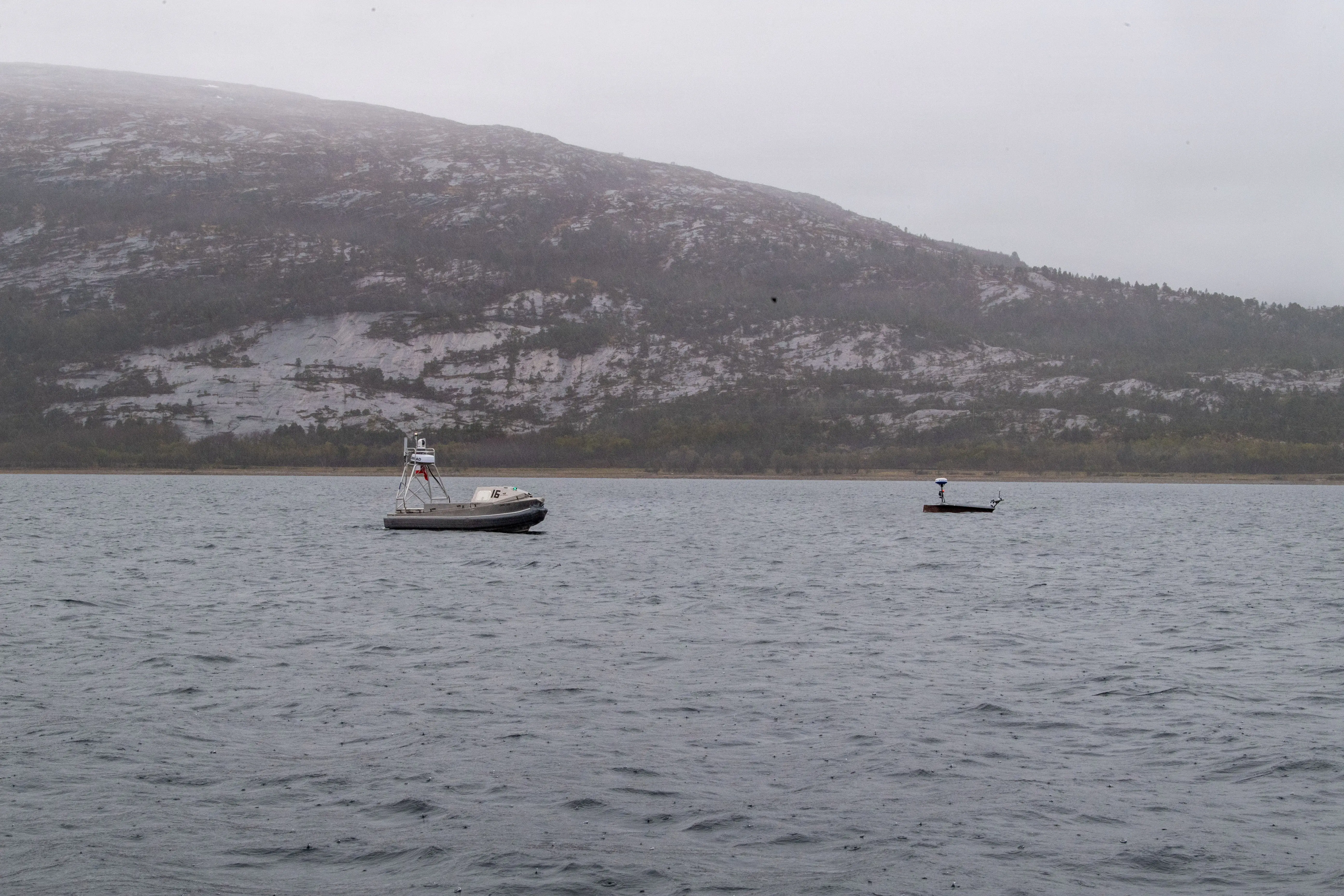 A Global Autonomous Reconnaissance Craft and Lightfish Unmanned Surface Vessel, attached to Commander, Task Force (CTF) 66, operates in Breivika Bay during Arctic Sentry 2026.