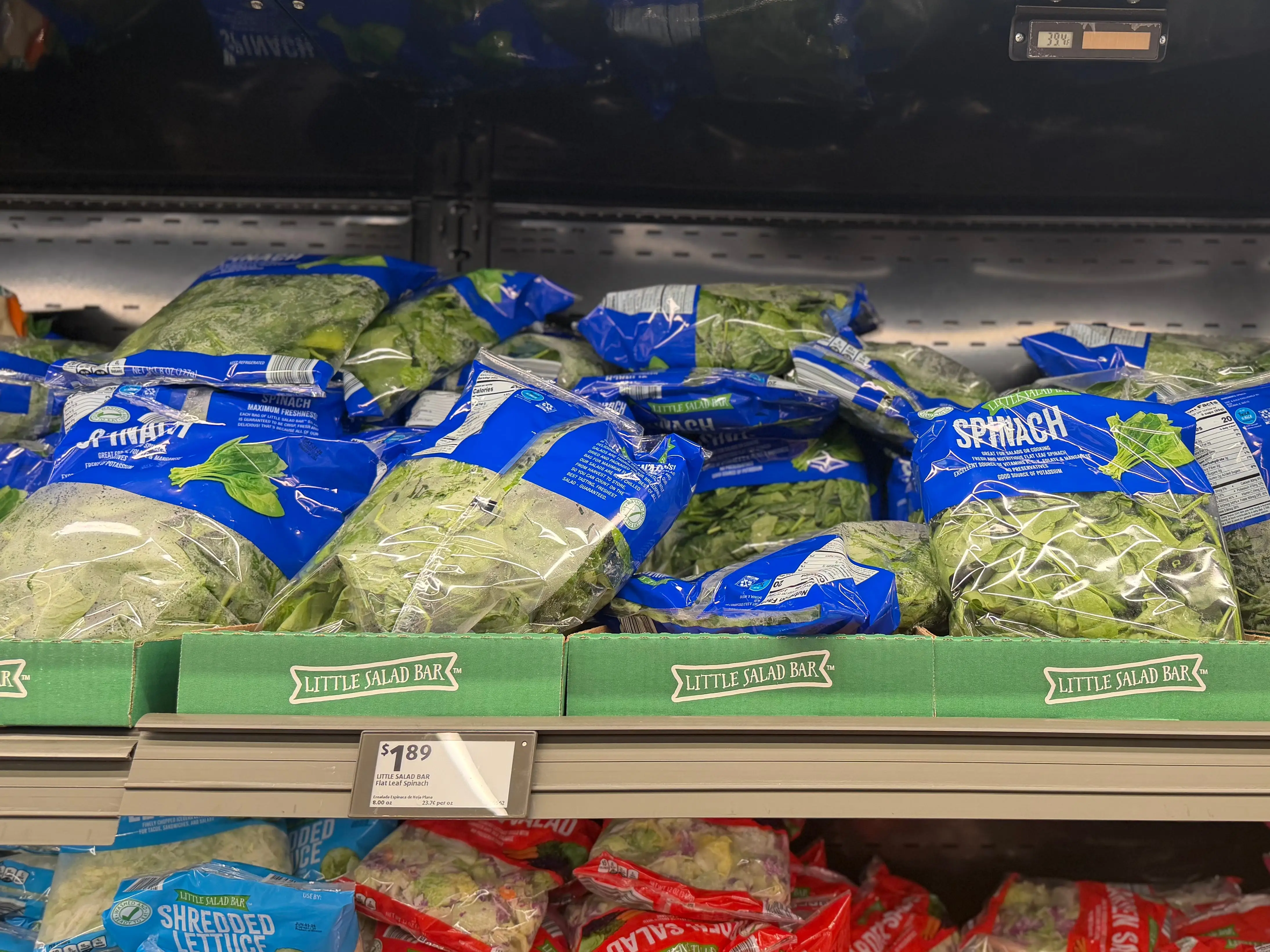 Bags of spinach on display at Aldi.