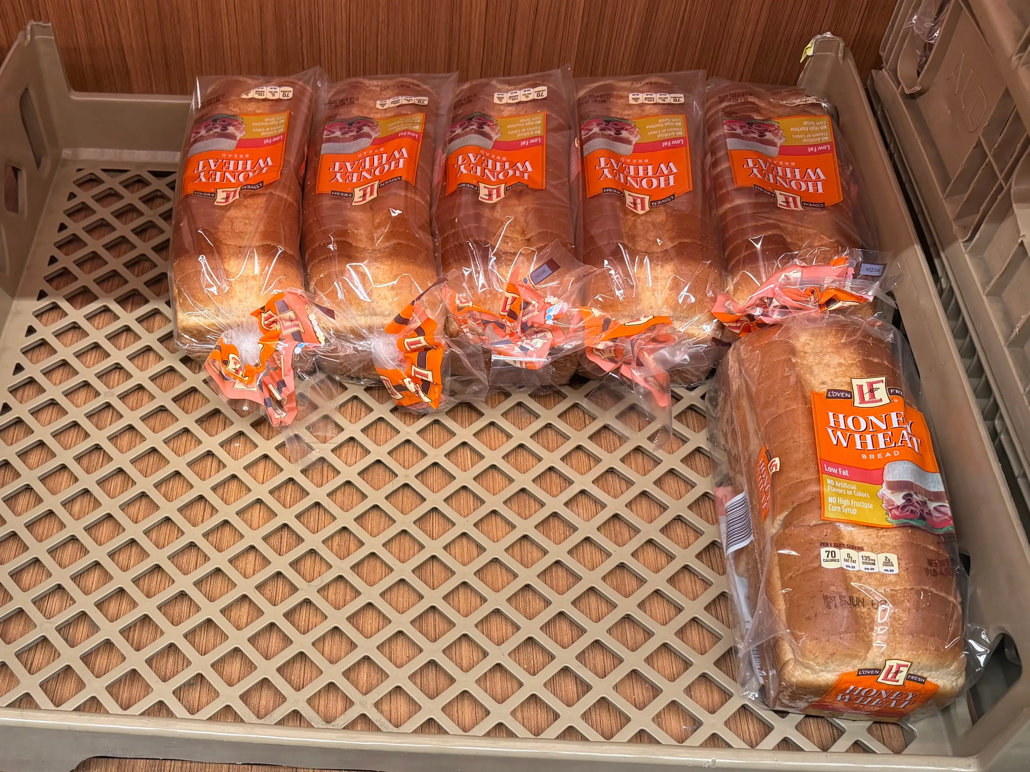 Loaves of honey-wheat bread on display at Aldi.