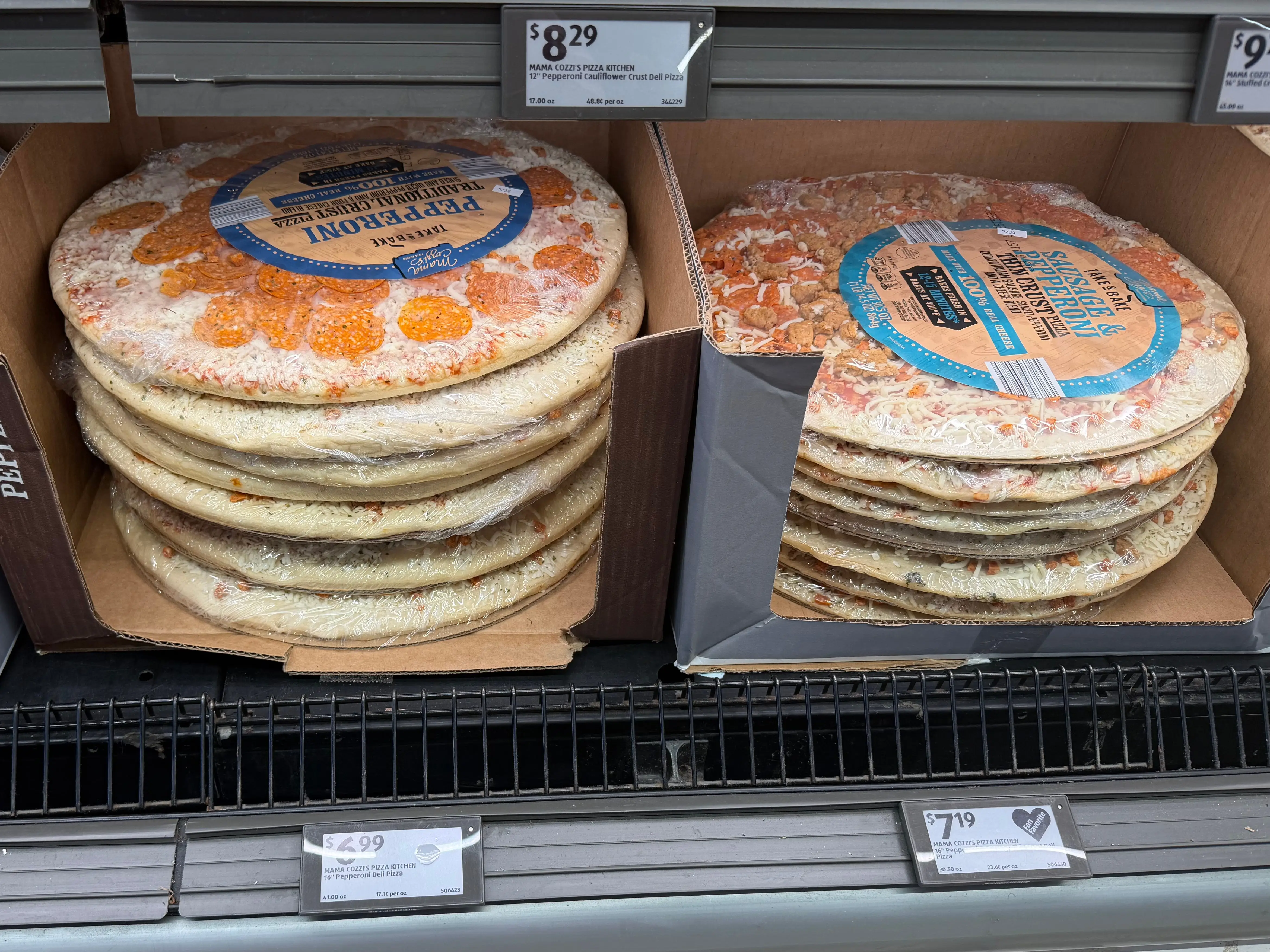 Frozen pepperoni pizzas in a freezer case at Aldi.