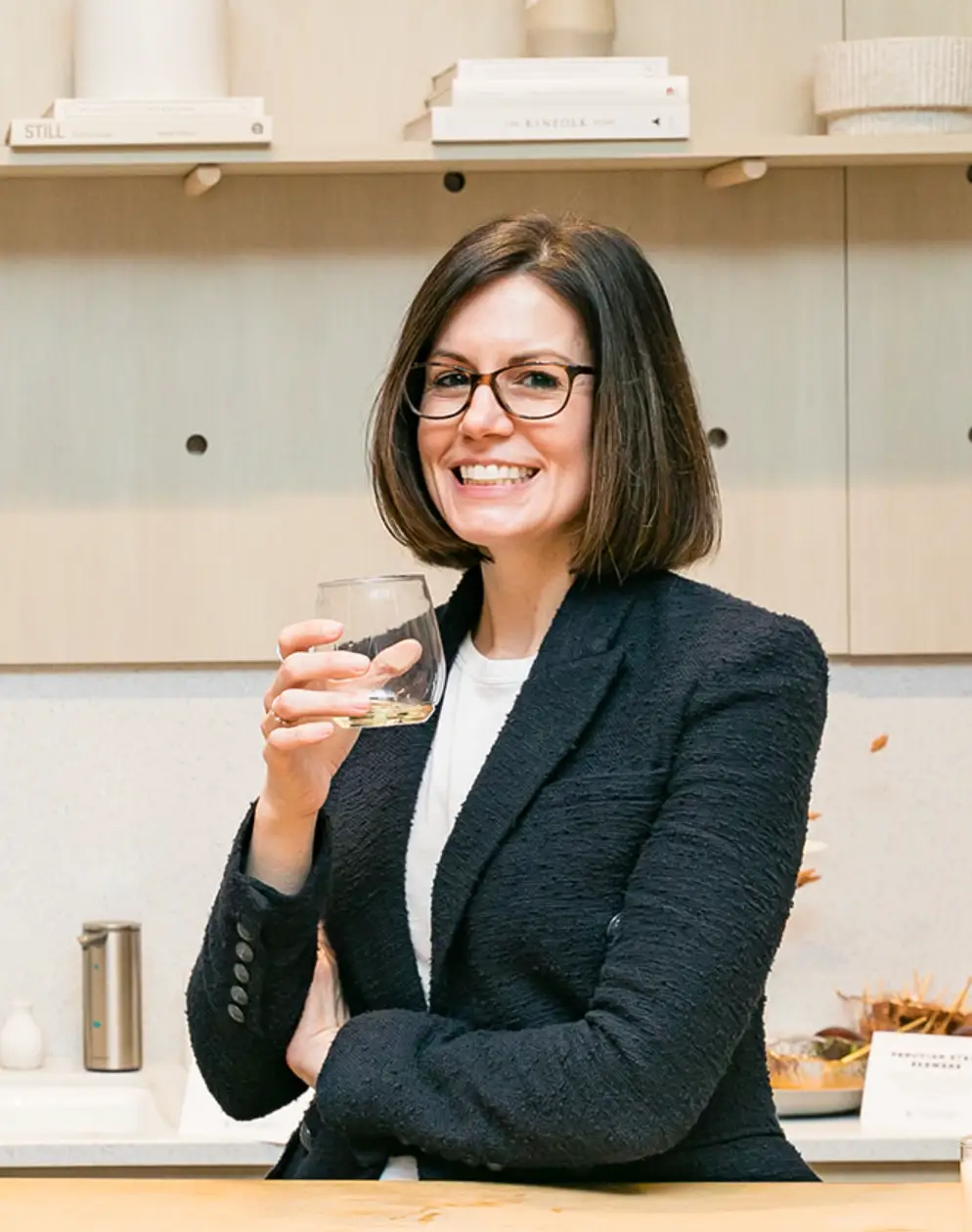 a headshot of the CEO of Avaline drinking a glass of wine