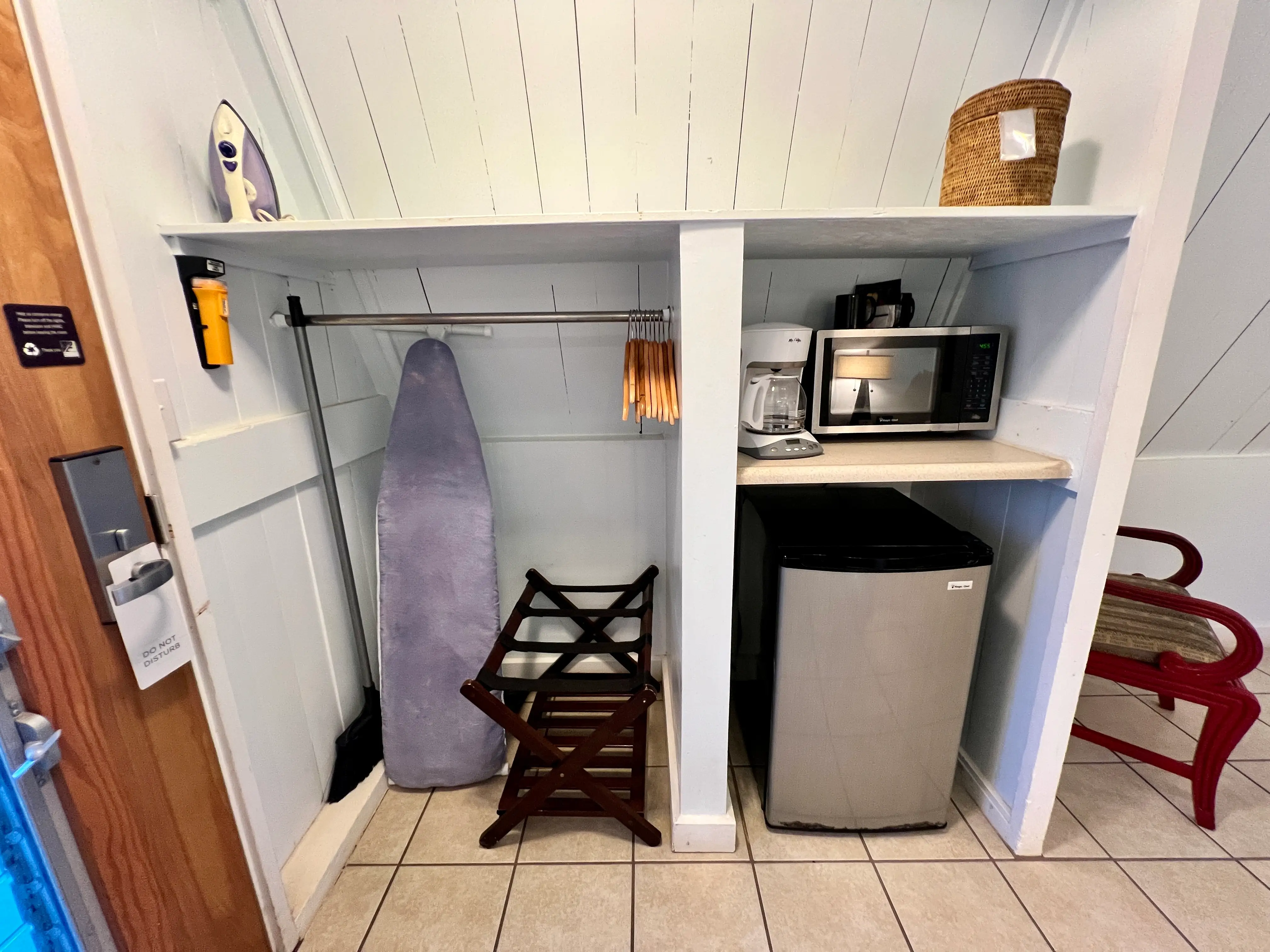 Mini fridge, coffee maker,  microwave, luggage rack, ironing board, iron and other amenities in shelving unit