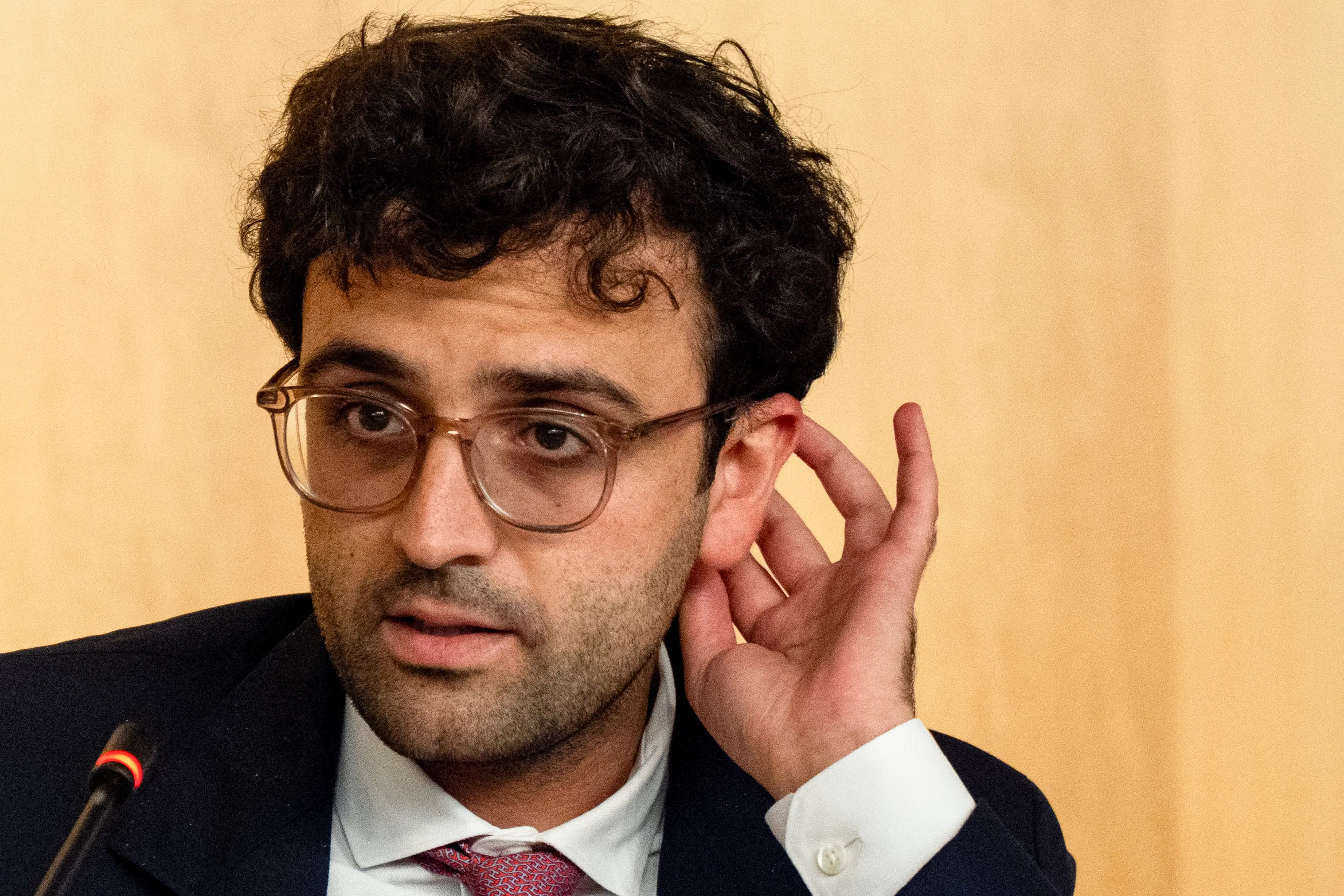 Tarek Mansour before a microphone