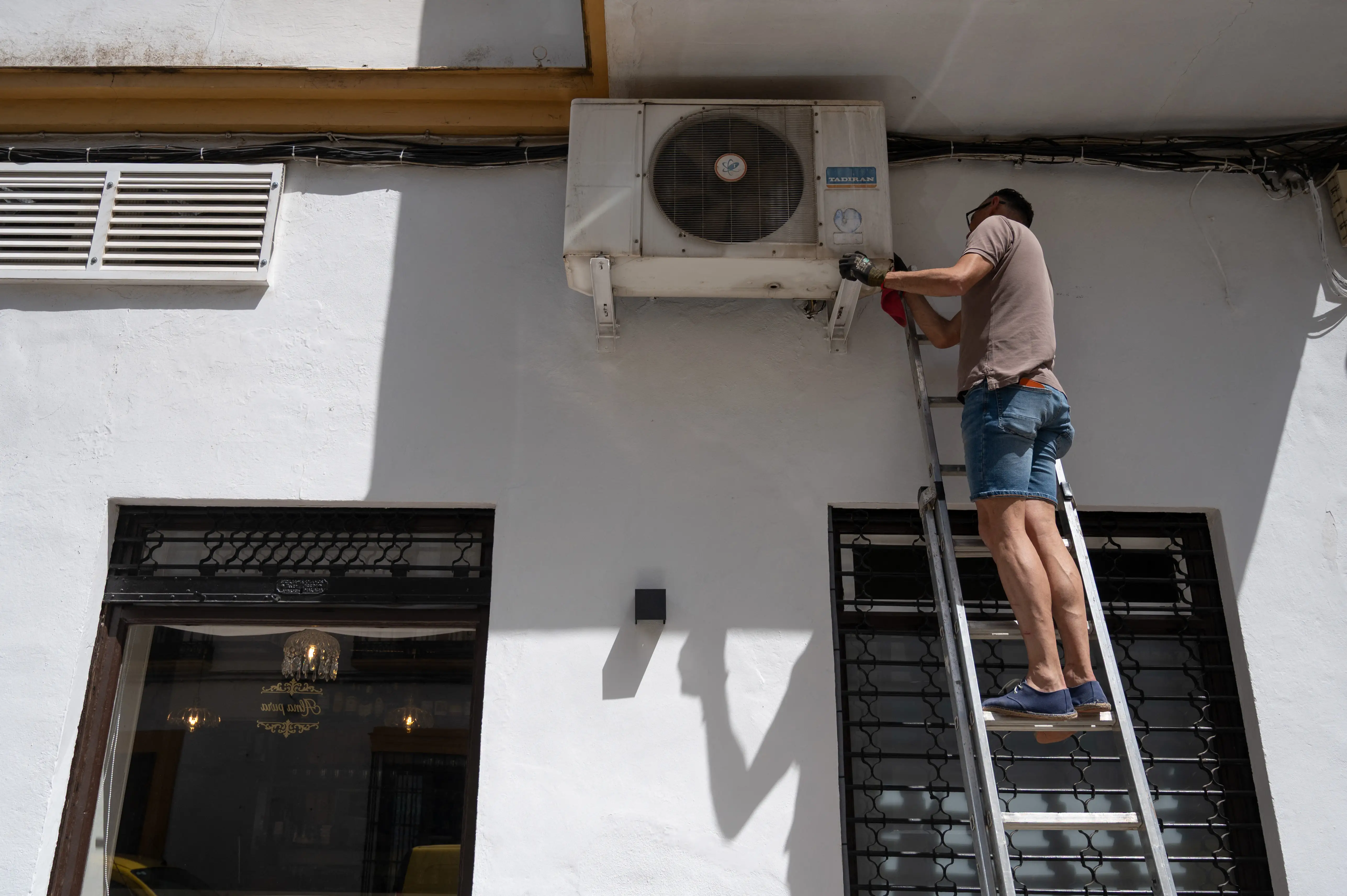 a man repairs and air con unit