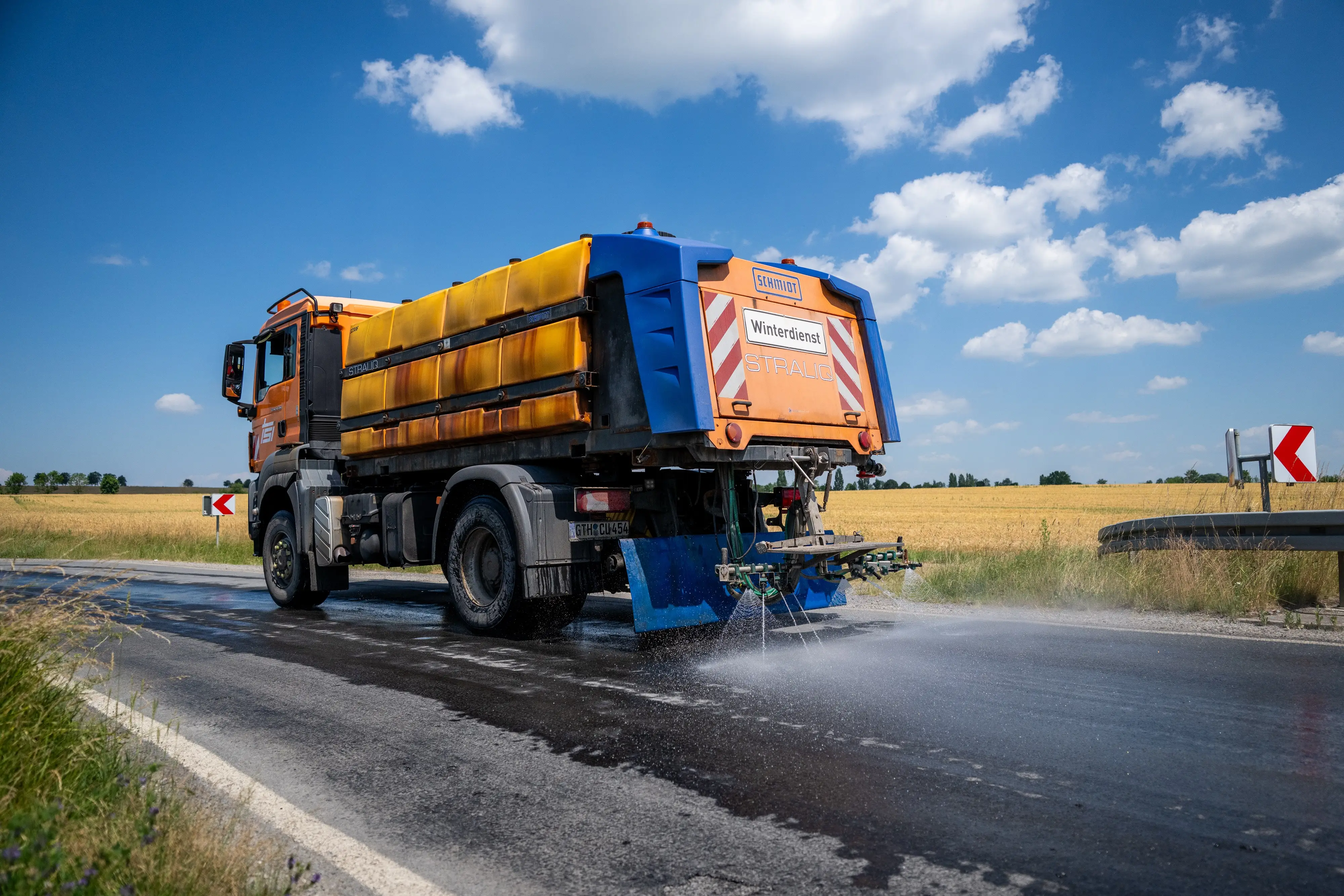 A winter maintenance vehicle sprays water on roads in Germany.