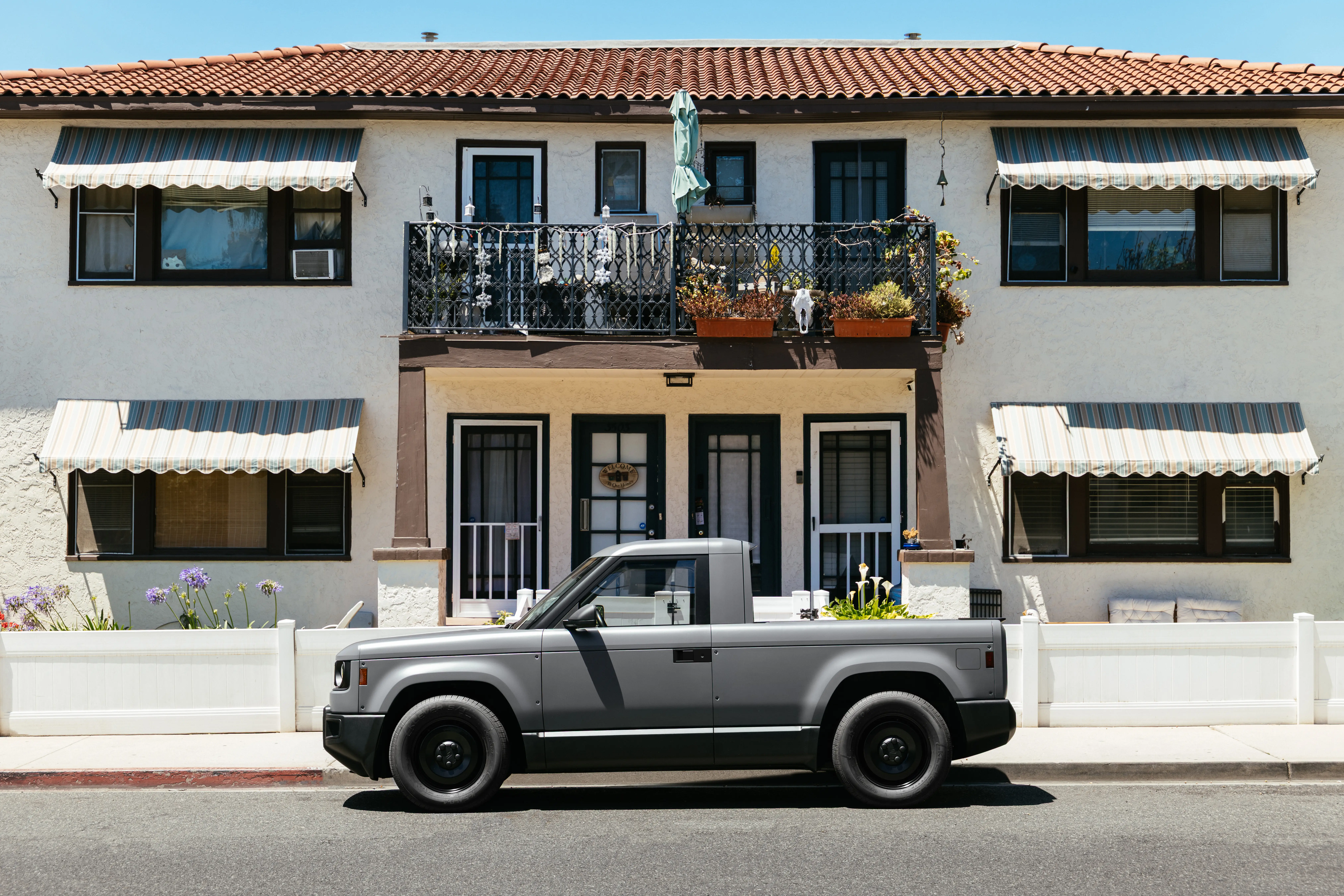 A Slate truck parked outside a light-colored home.
