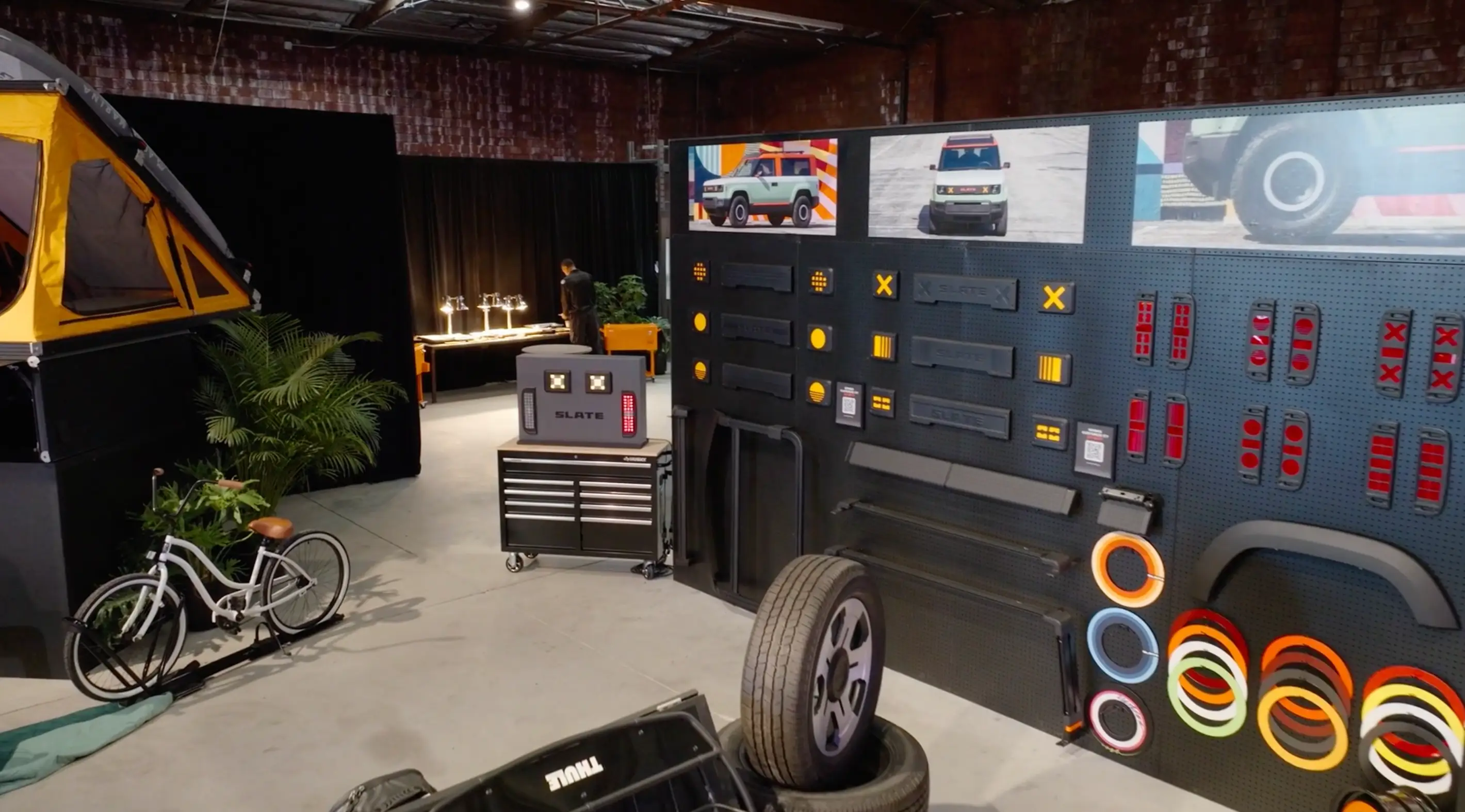 A display of several exterior options, including front fascia boards, light covers, tents, wheel covers, and a bike rack.
