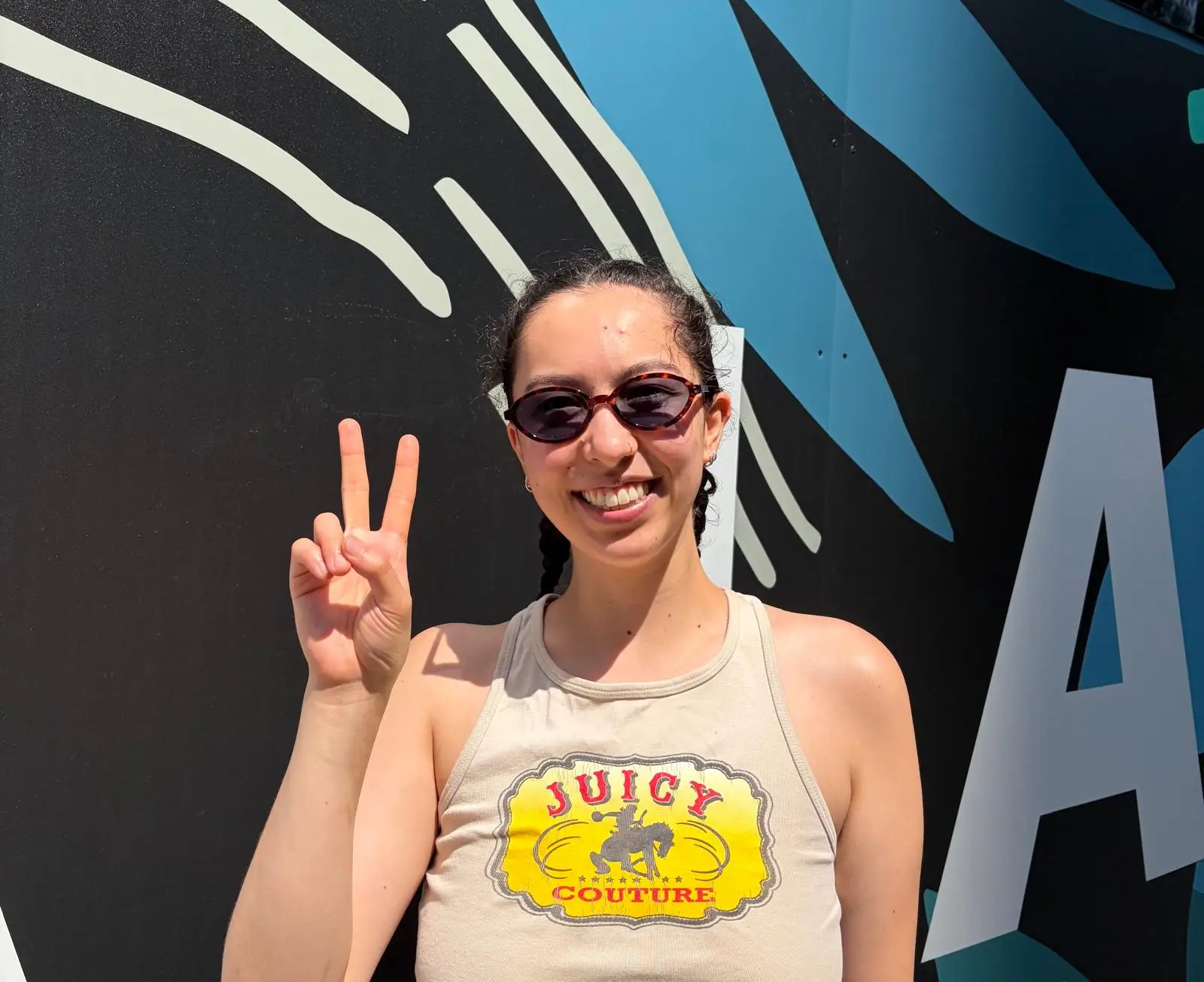 a young woman does a peace sign
