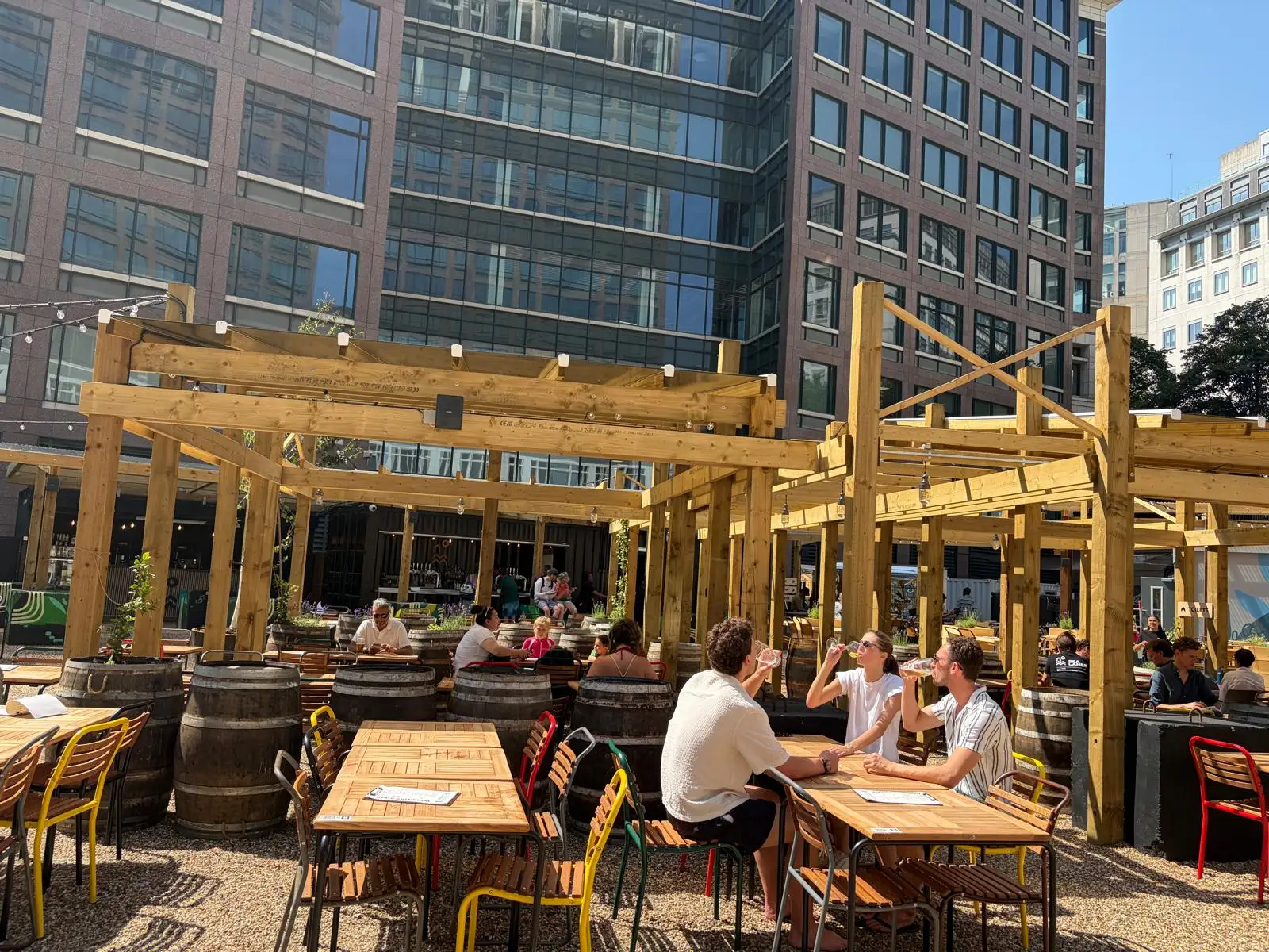 people sit by a pool deck in Canary Wharf