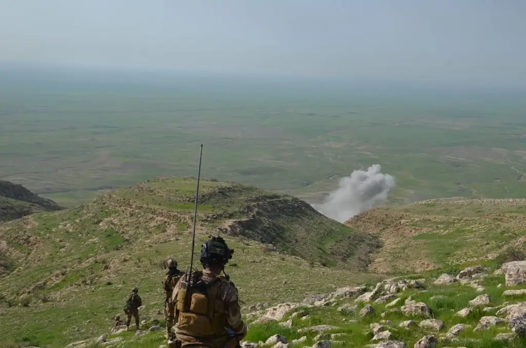 Open terrain in Iraq with American soldiers.