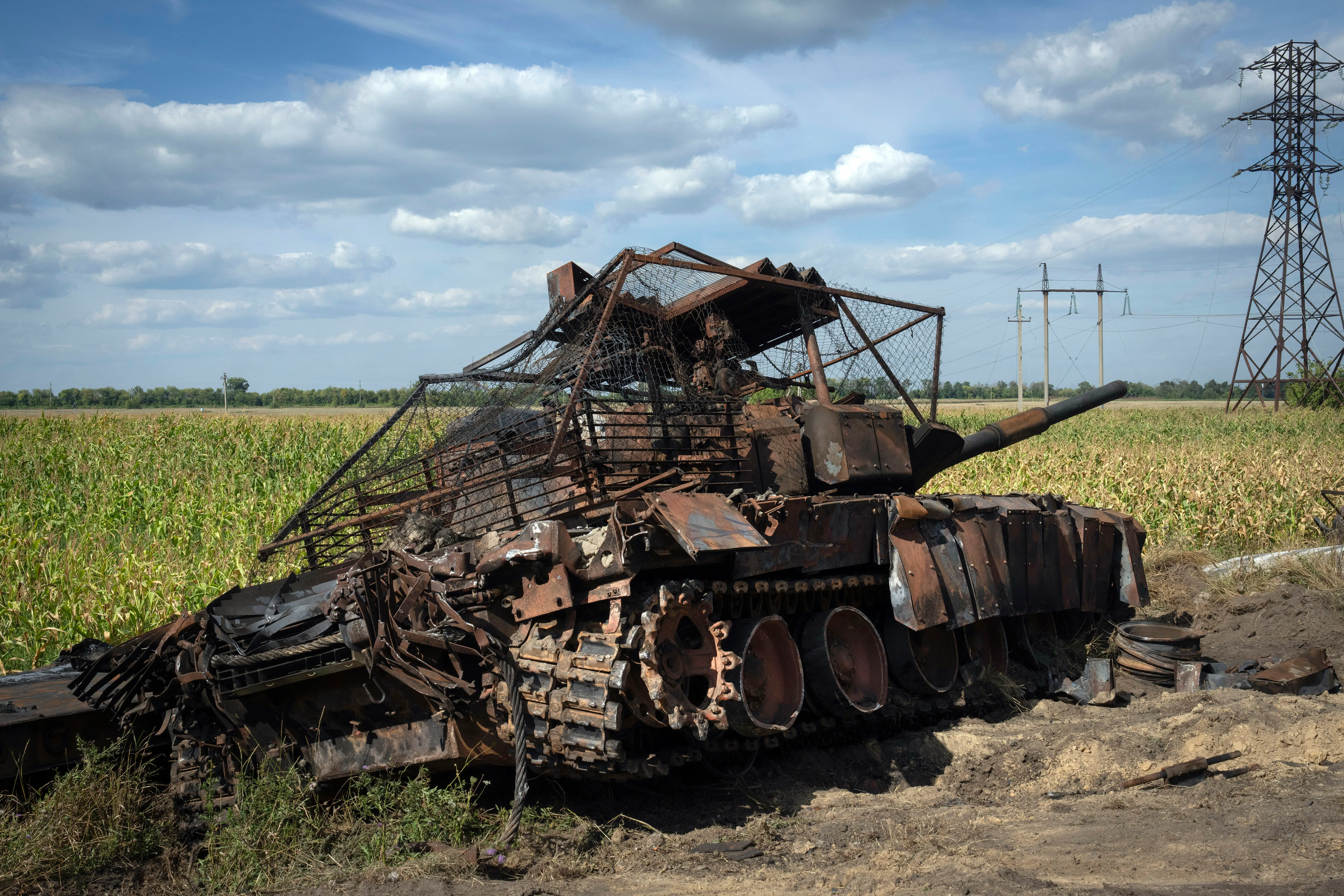 A destroyed Russian tank sits on a roadside near the town of Sudzha, Russia, in the Kursk region.