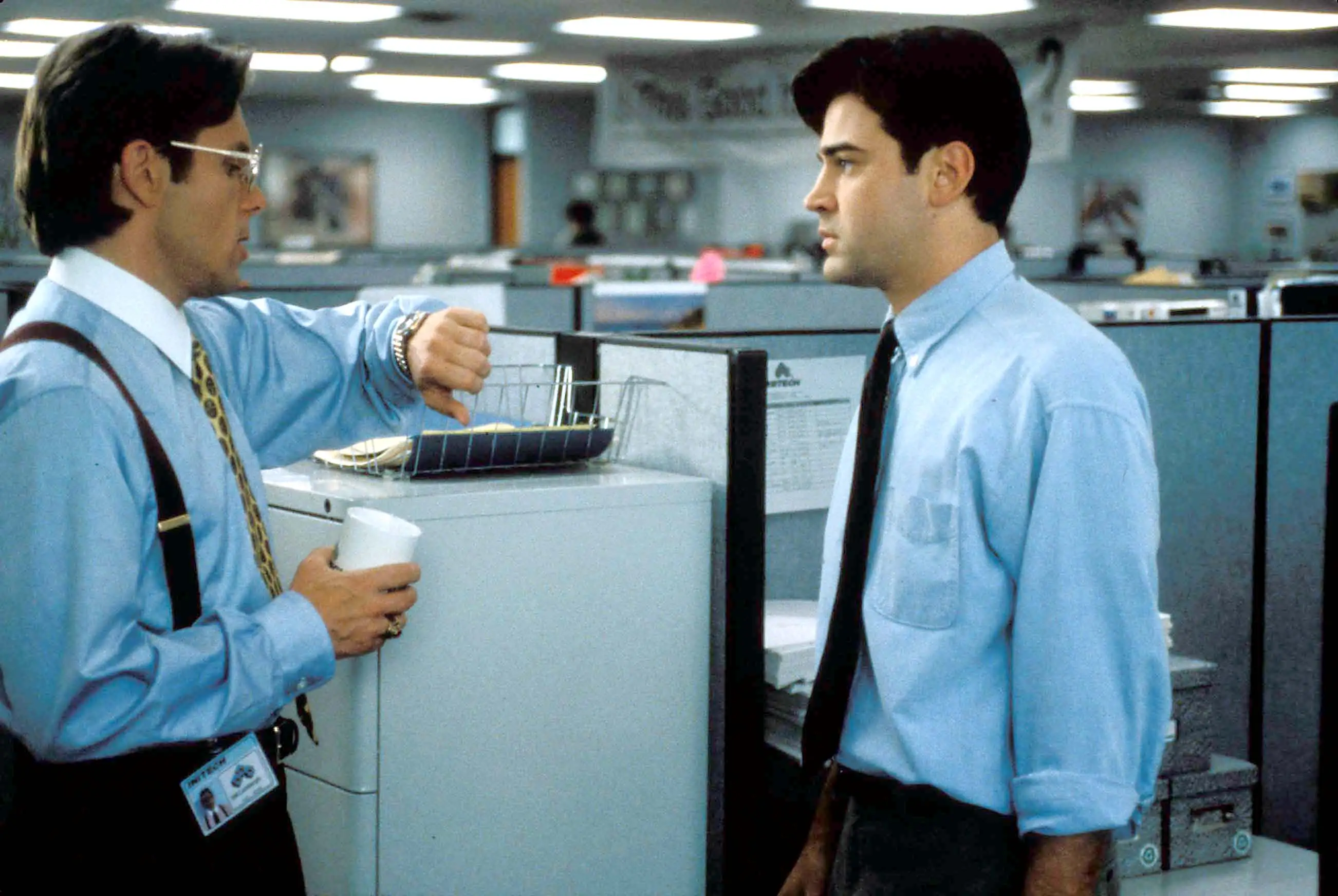 Manager Bill Lumberg, played by Gary Cole (left), checks in with his employee in the movie Office Space.