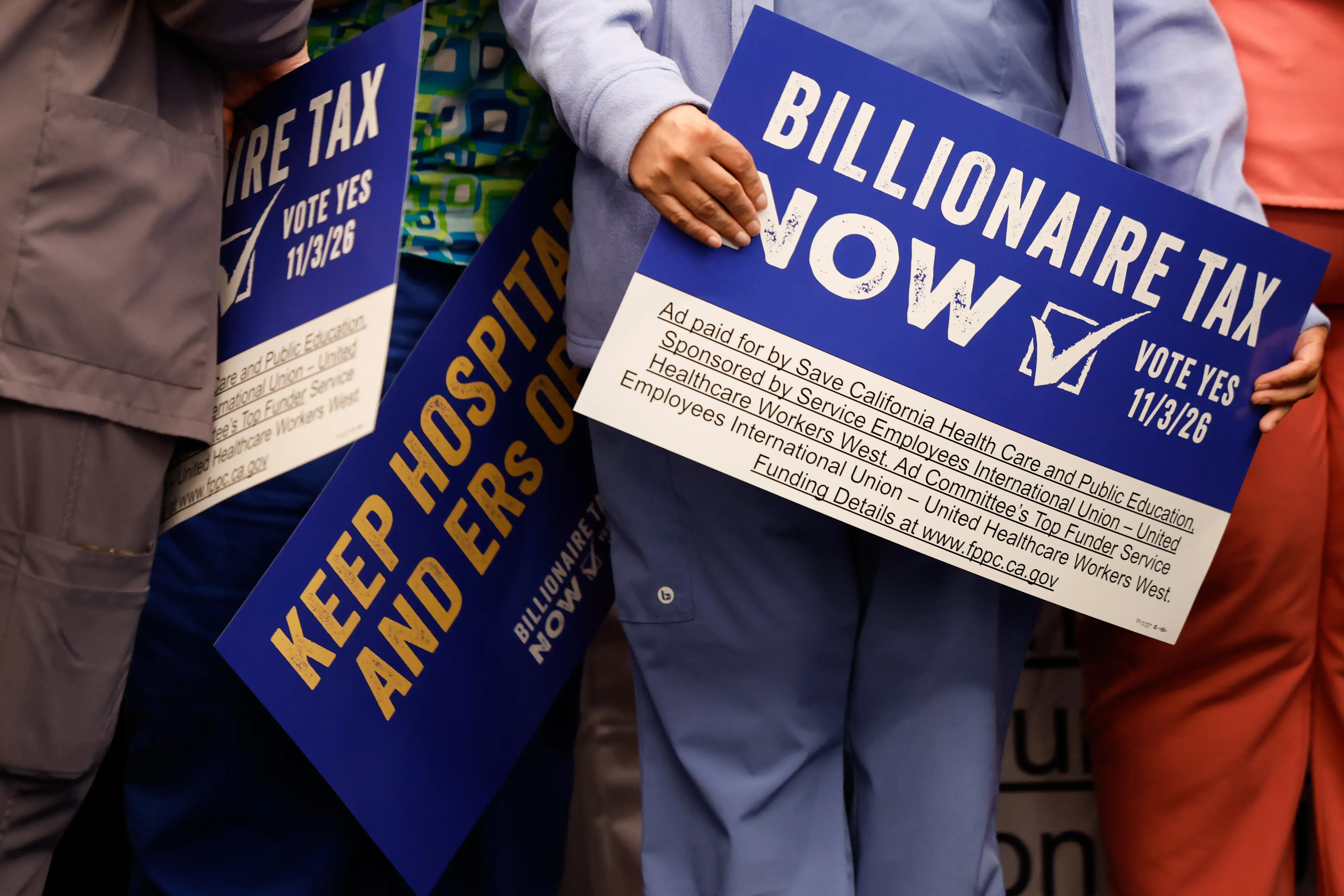 People holding signs that say 